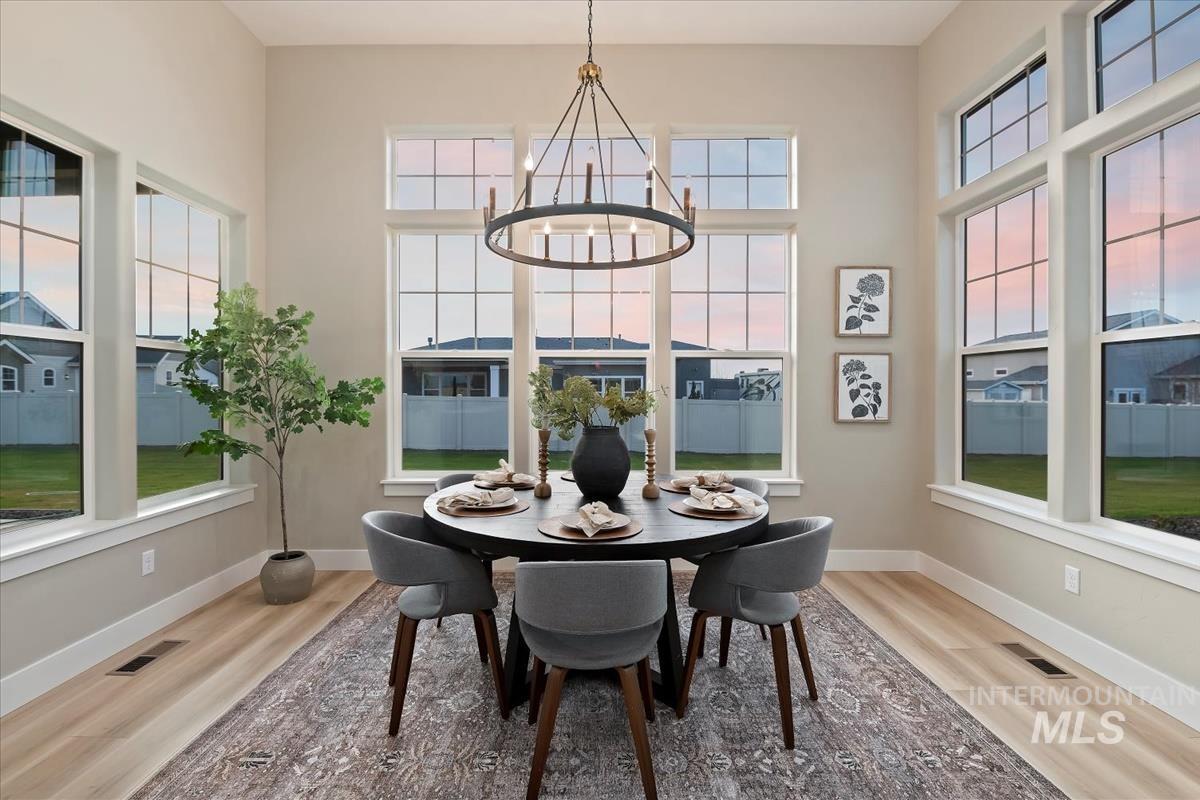 Dining room featuring light wood finished floors and a chandelier