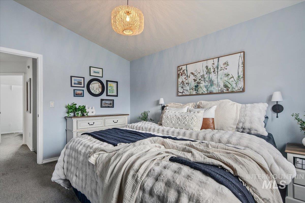 Bedroom featuring vaulted ceiling and carpet flooring