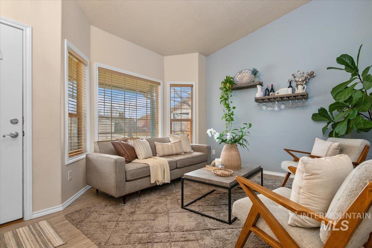Living area featuring light wood-type flooring and baseboards
