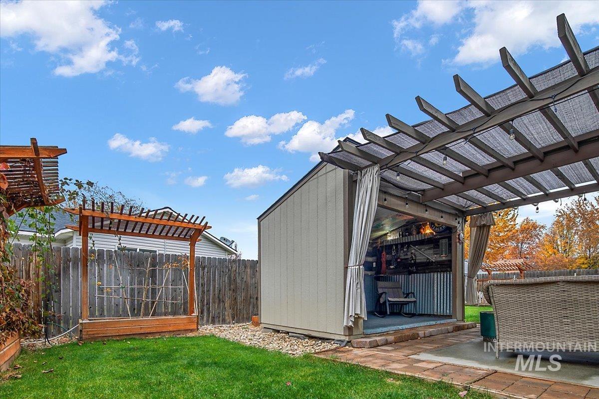 View of outdoor structure featuring a pergola and a fenced backyard