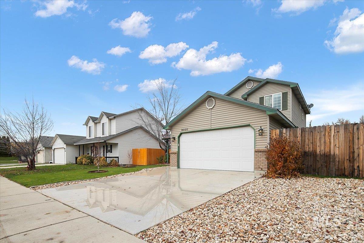 Traditional-style home featuring brick siding, concrete driveway, and an attached garage