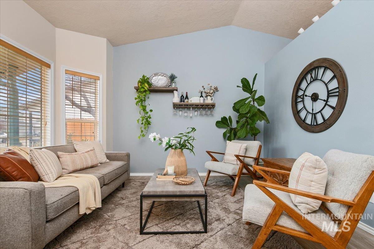 Living area featuring lofted ceiling and a textured ceiling