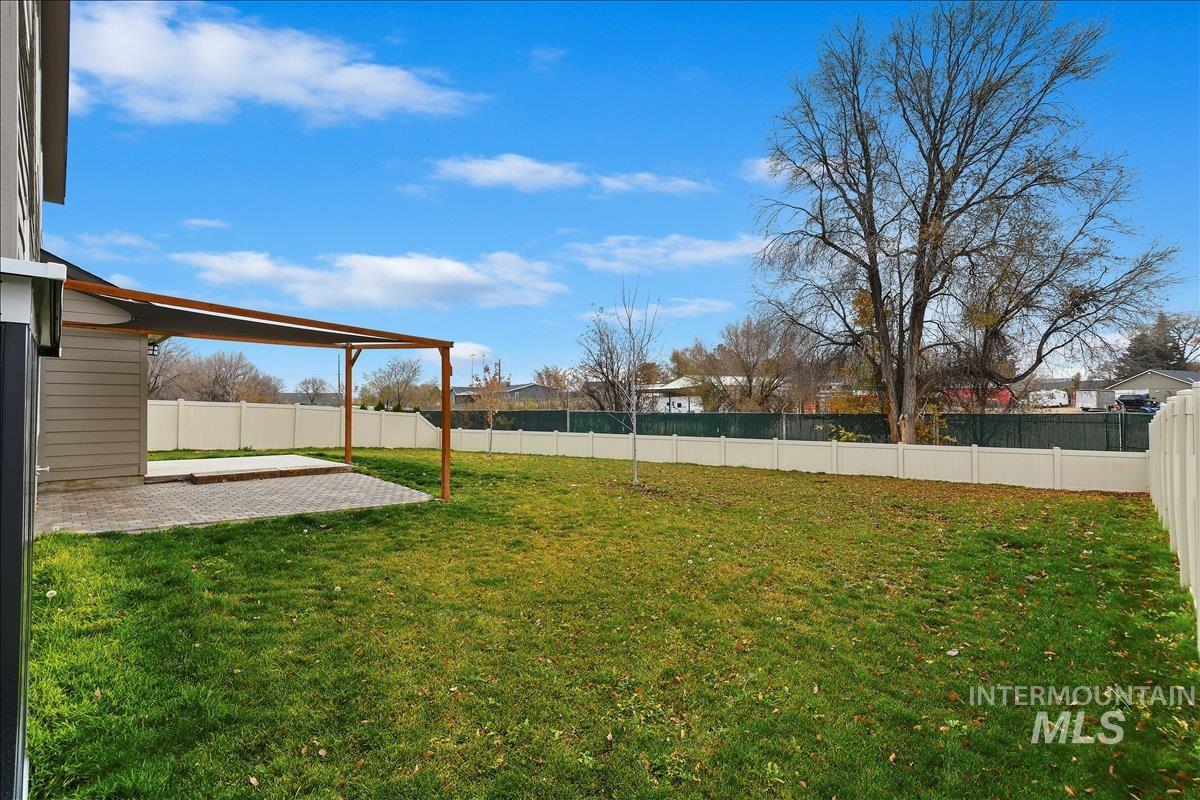 Fenced backyard with a patio