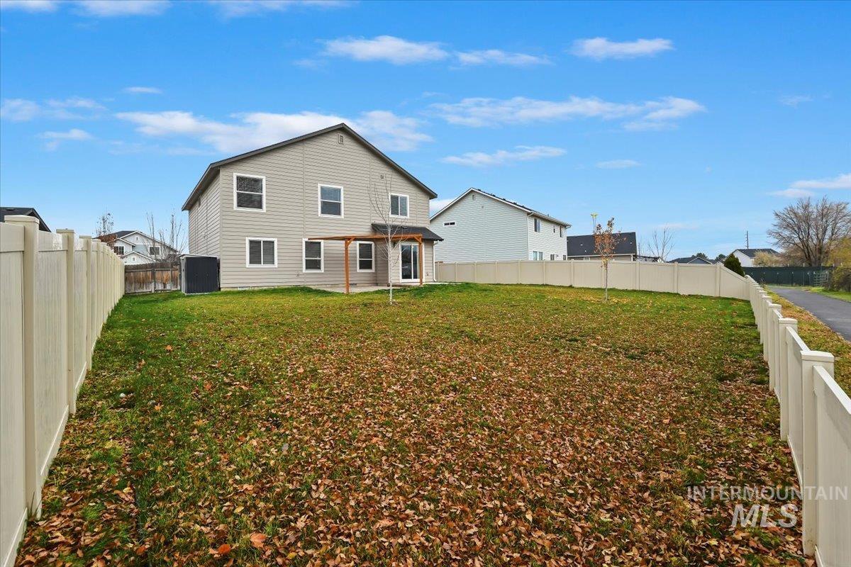 Back of house with a fenced backyard