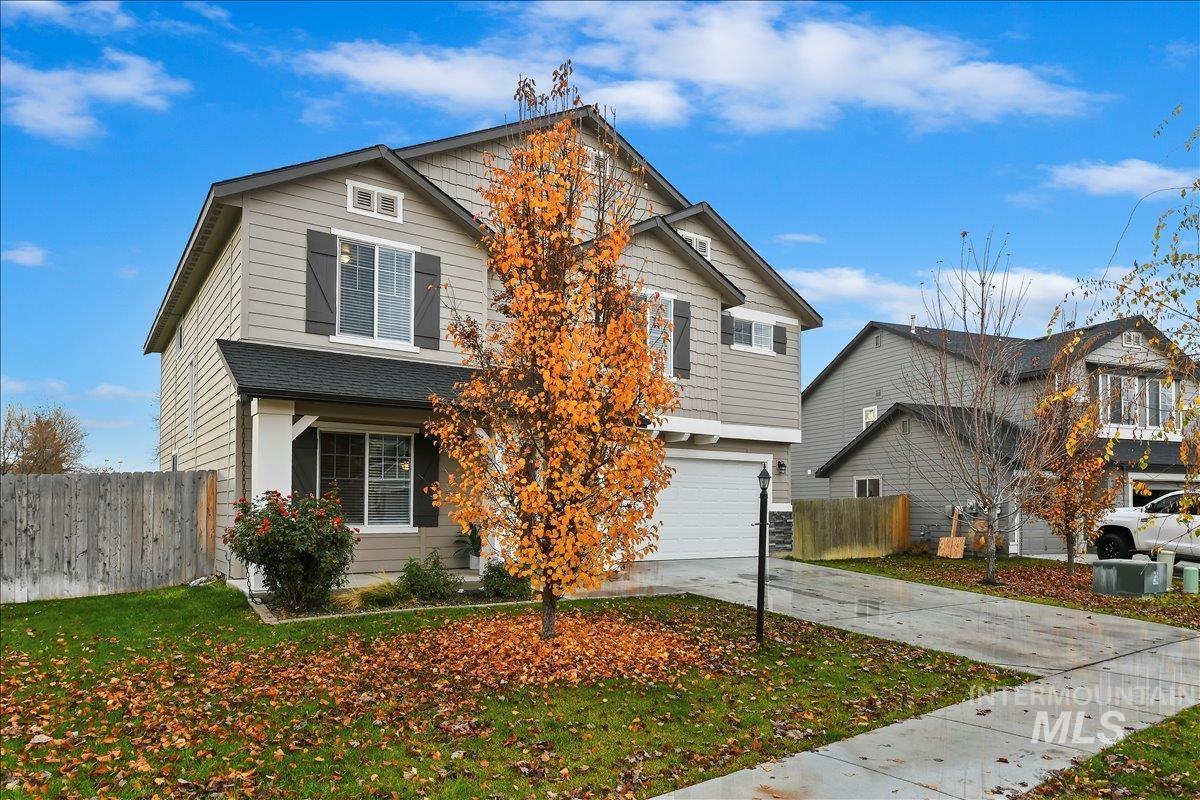 Traditional-style house featuring driveway and an attached garage