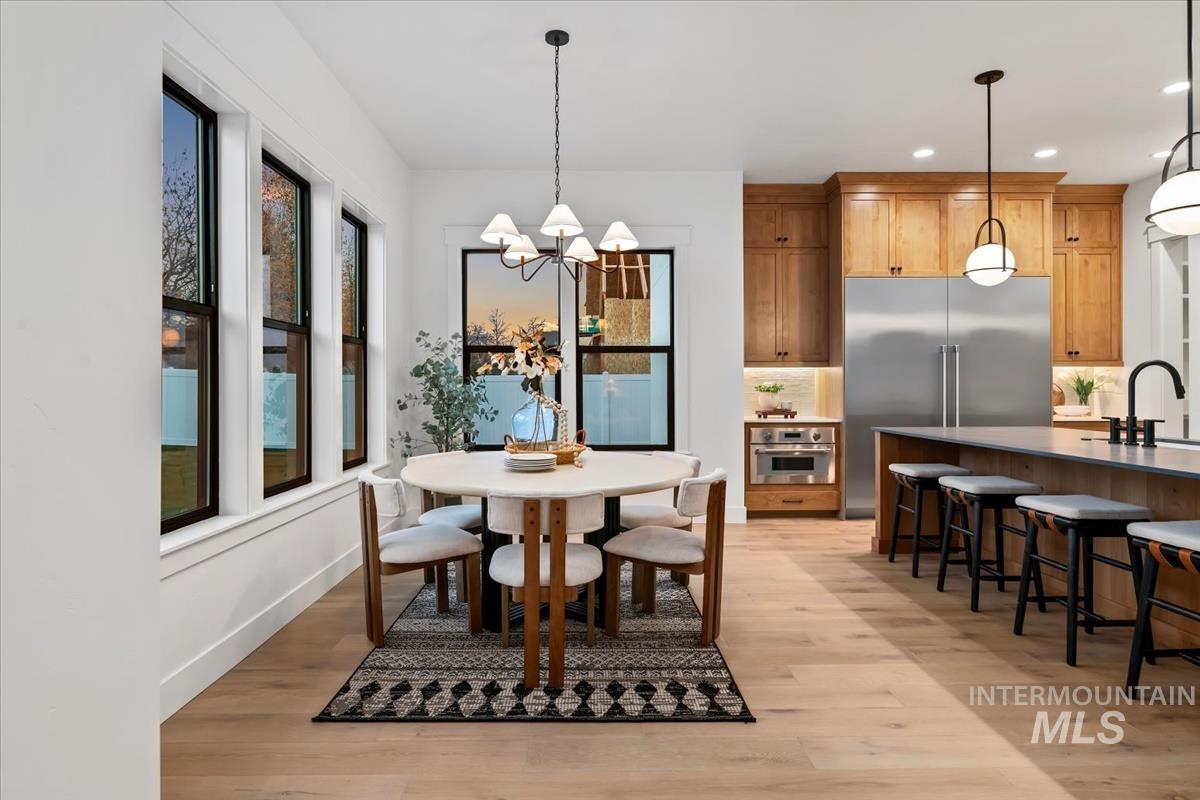 Dining space featuring a chandelier, light wood finished floors, and recessed lighting