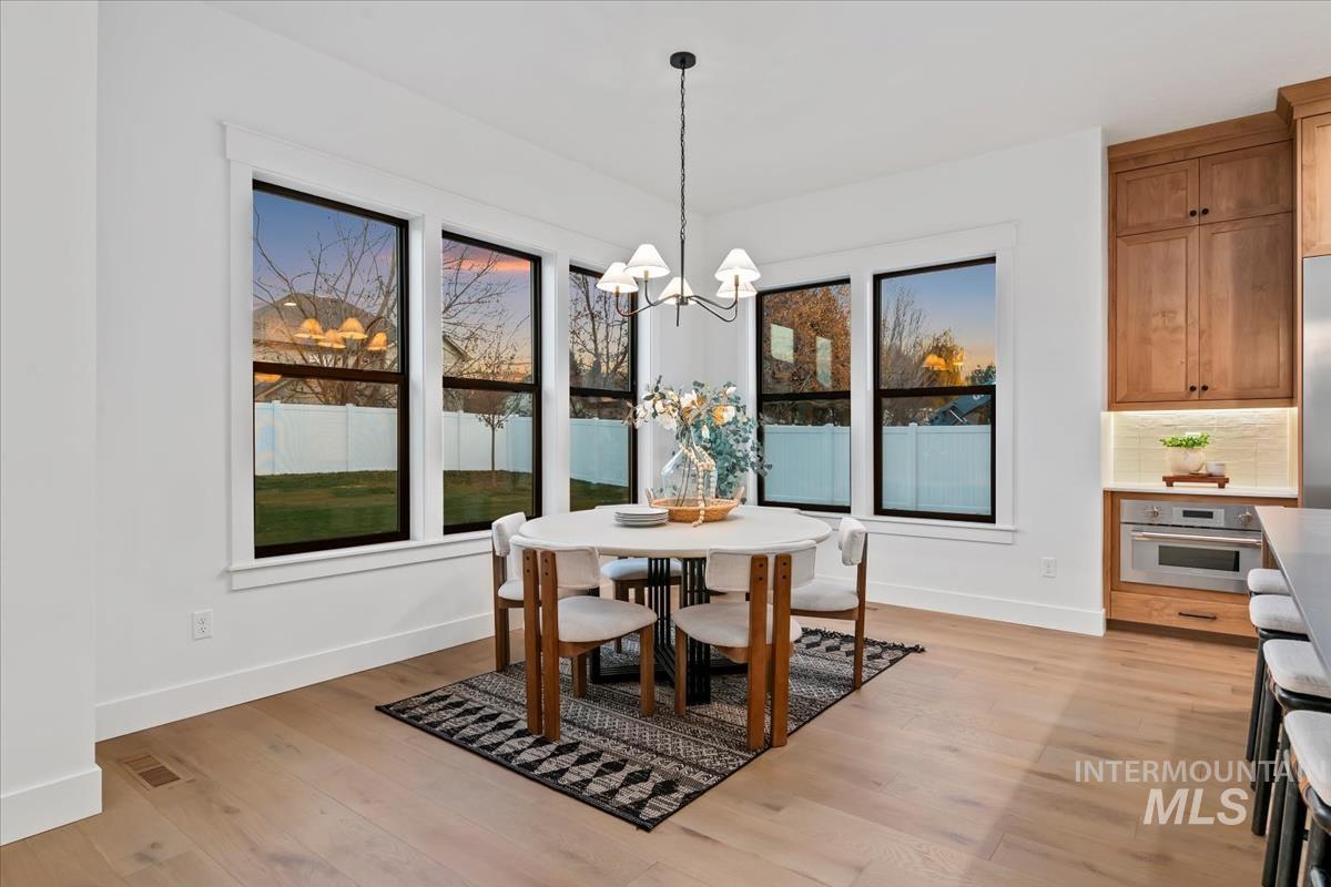 Dining room featuring light wood-style flooring and a chandelier
