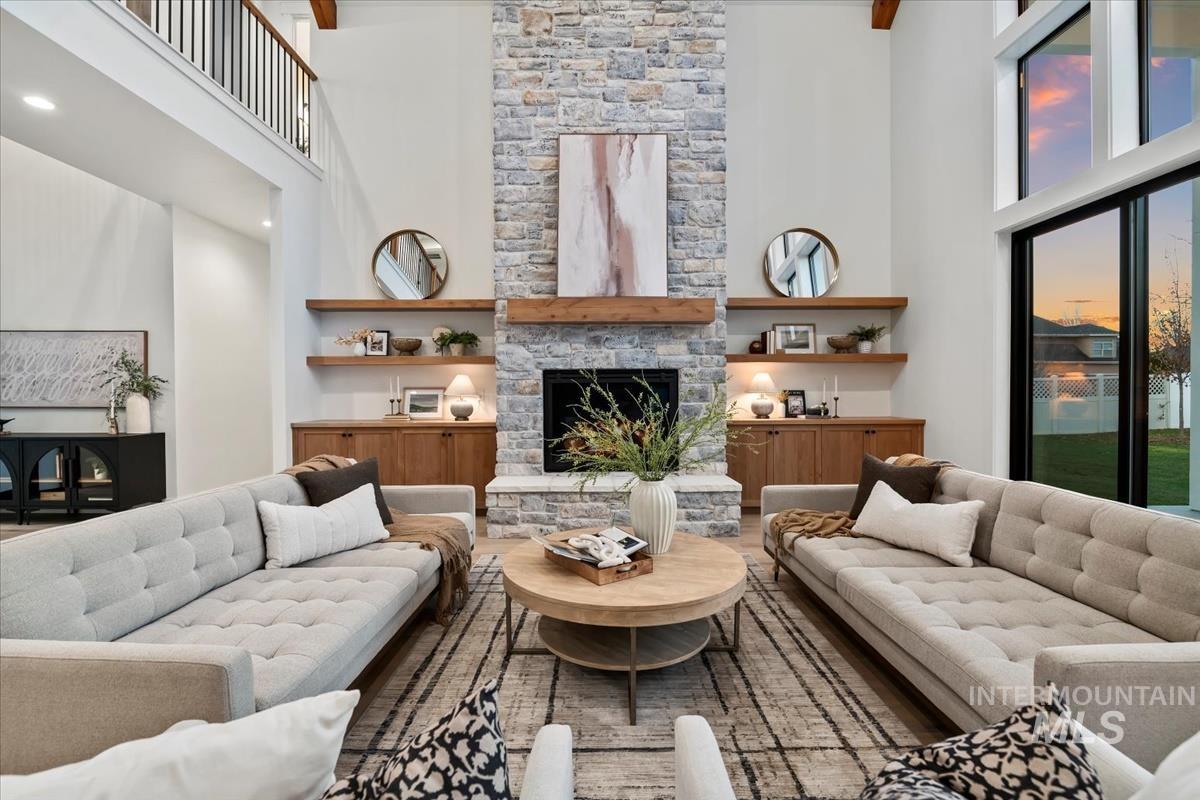 Living room featuring a high ceiling and a fireplace