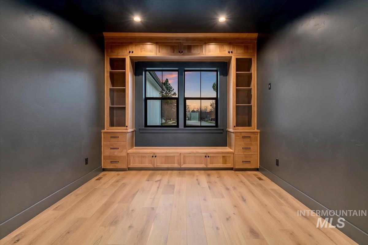 Spare room featuring light wood finished floors and baseboards