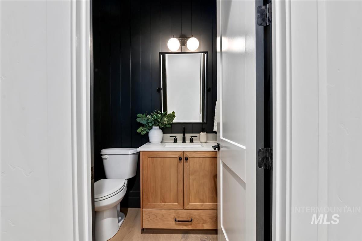 Half bath featuring vanity and light wood finished floors