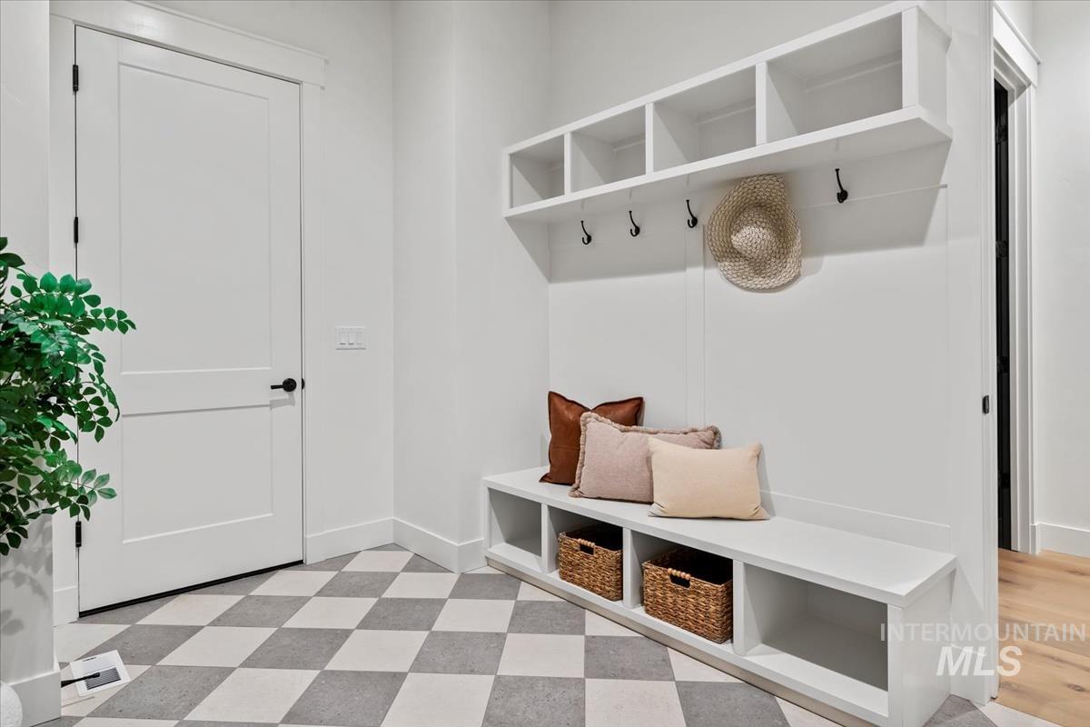 Mudroom with light floors and baseboards