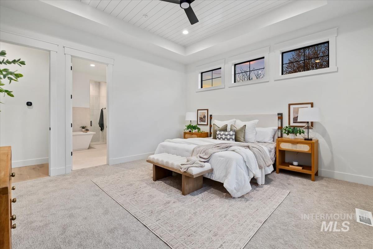 Bedroom featuring a ceiling fan, a tray ceiling, light colored carpet, recessed lighting, and wood ceiling