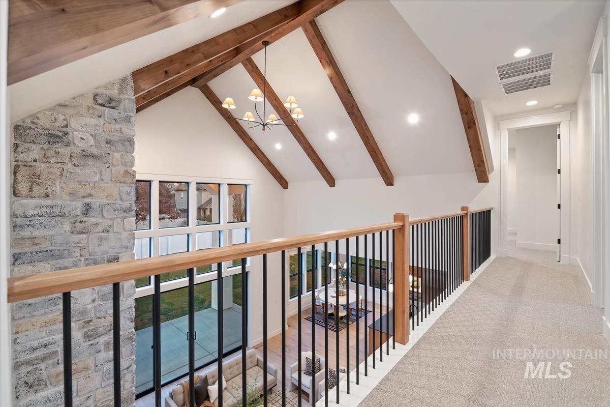 Hallway with recessed lighting, a chandelier, and carpet floors