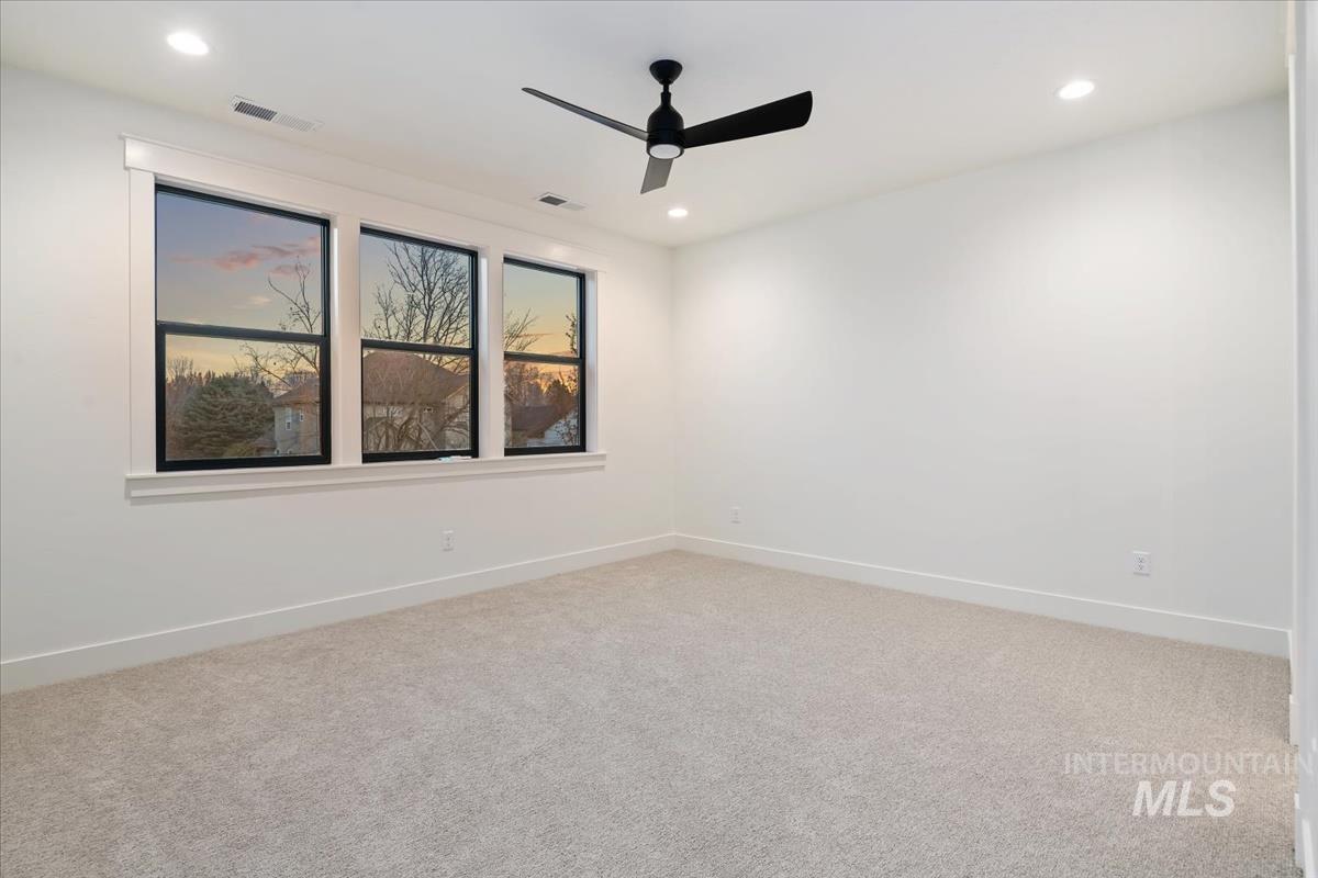Unfurnished room with light colored carpet, ceiling fan, and recessed lighting