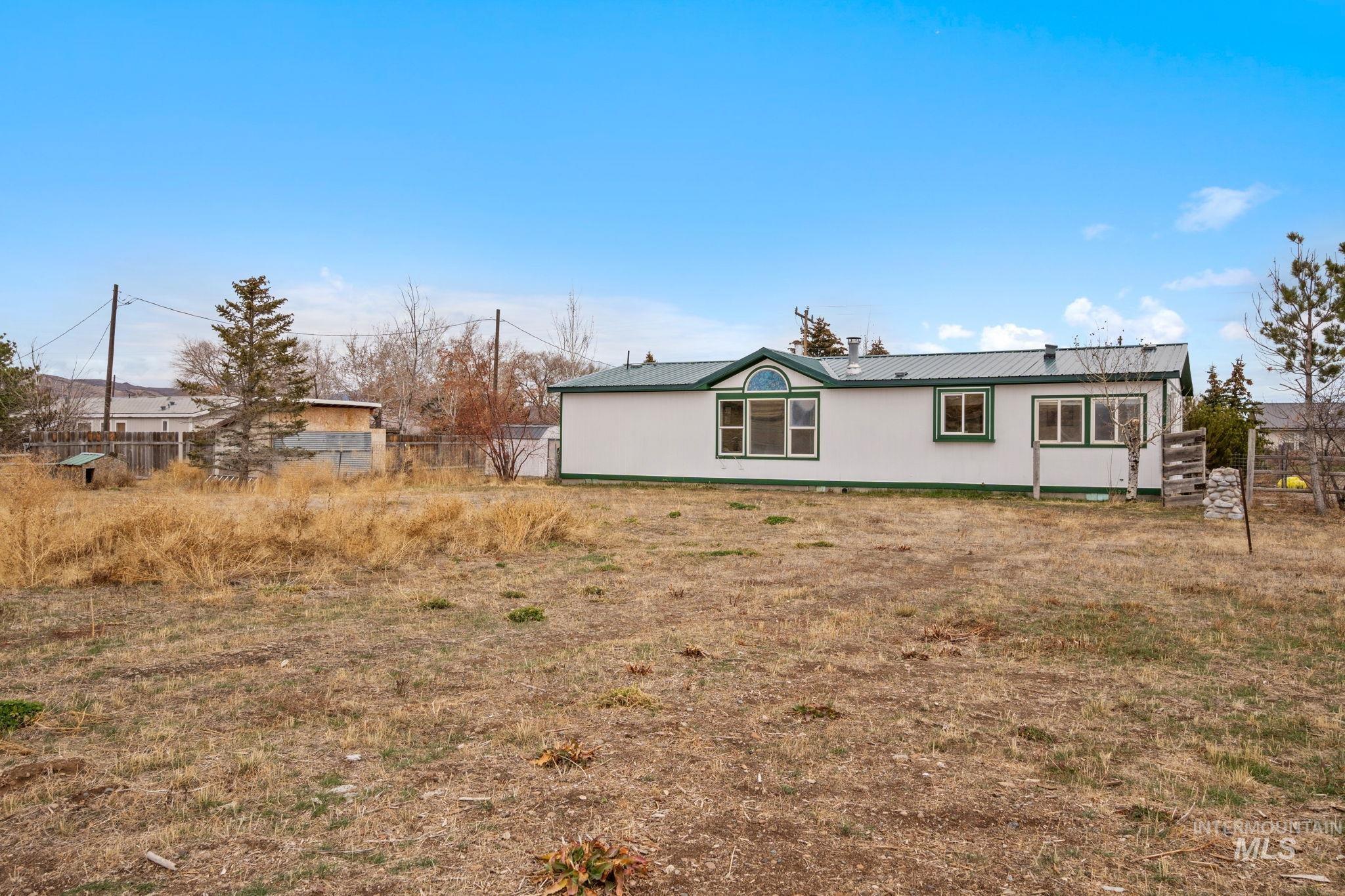 Rear view of house featuring a metal roof