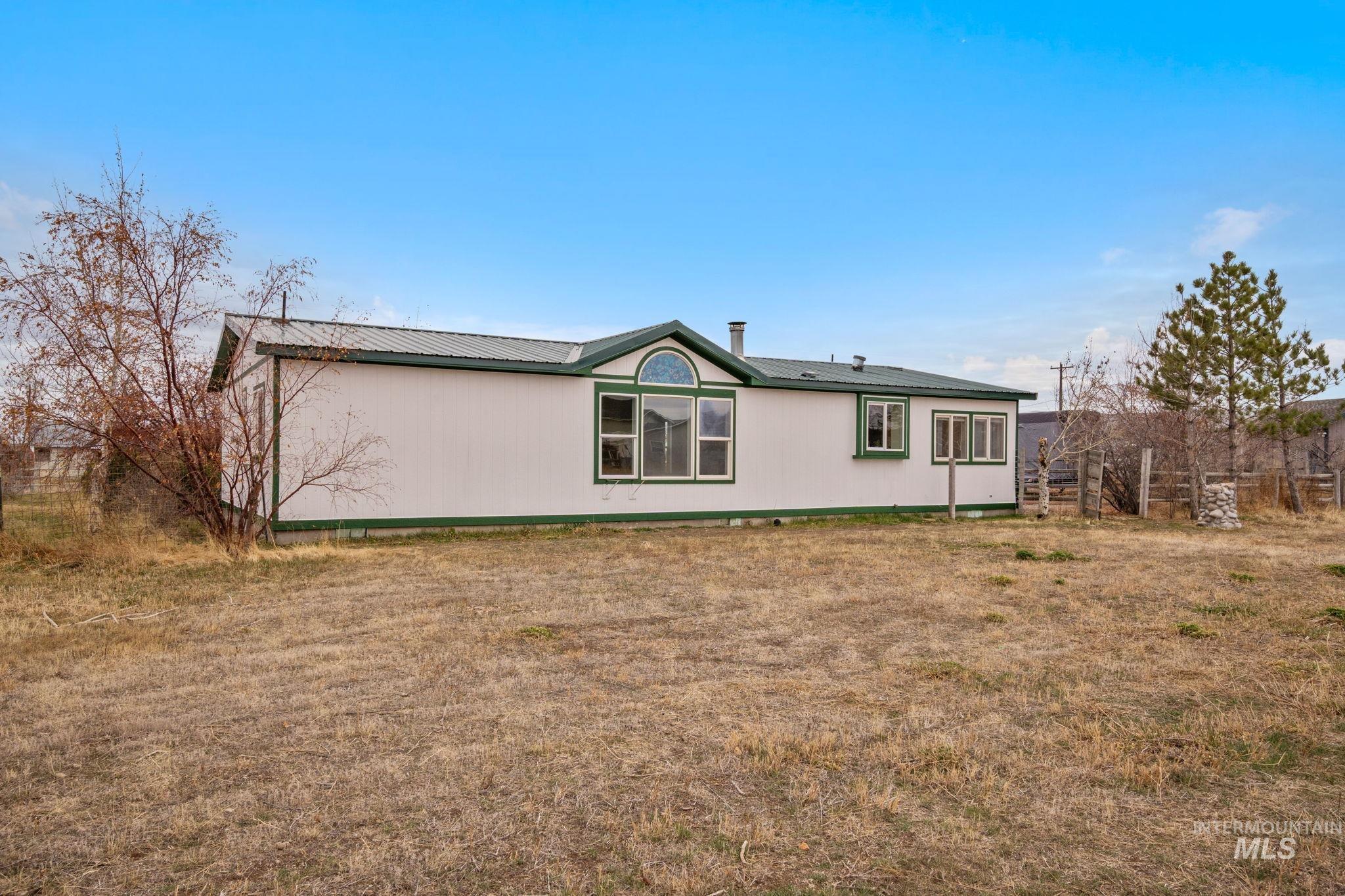 Back of house featuring a metal roof