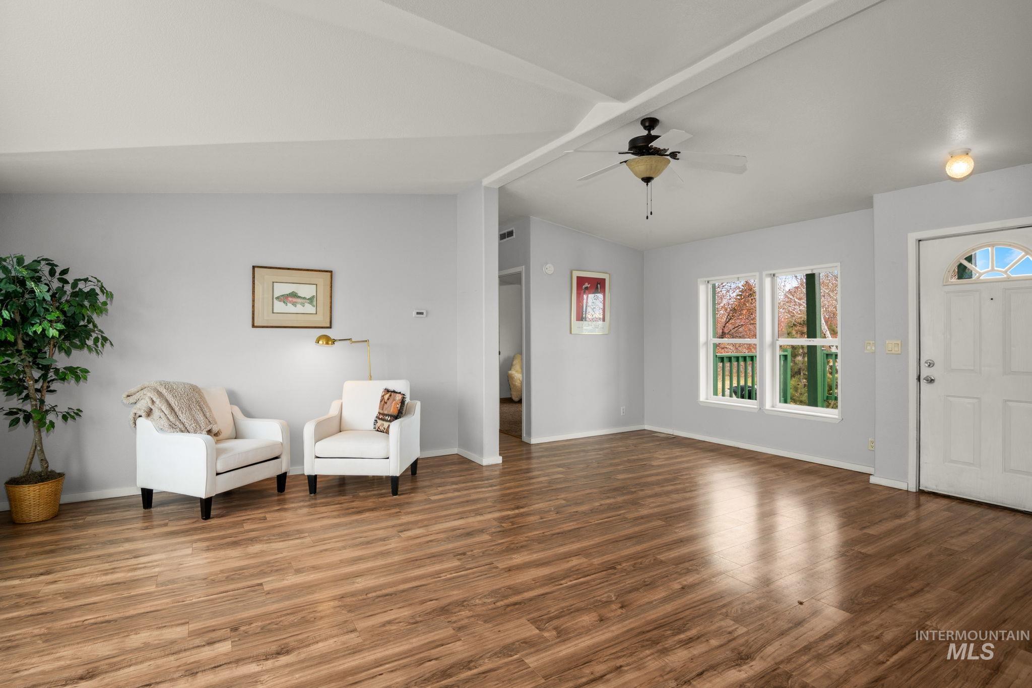 Living area featuring wood finished floors and ceiling fan