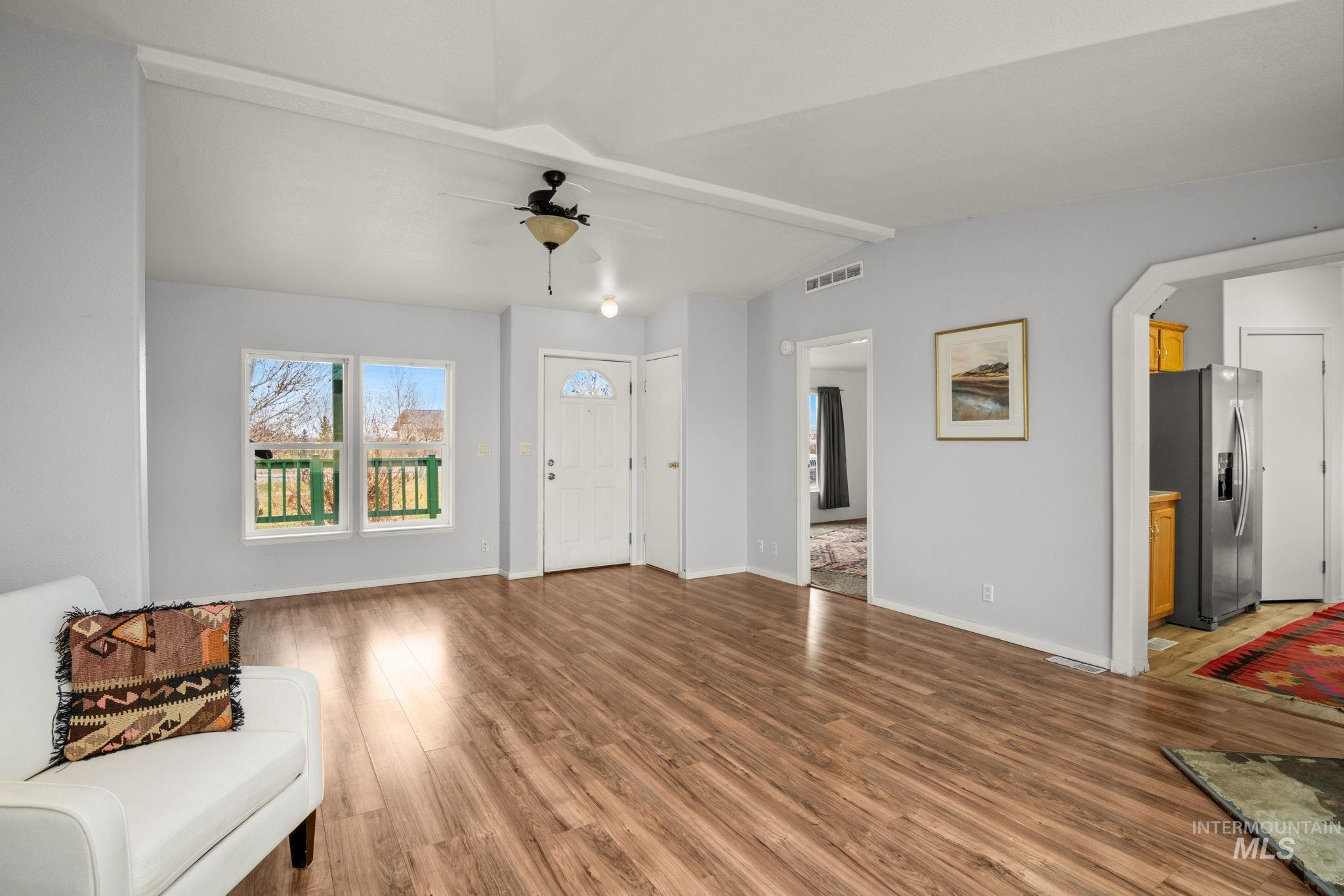 Entrance foyer featuring light wood-type flooring and ceiling fan