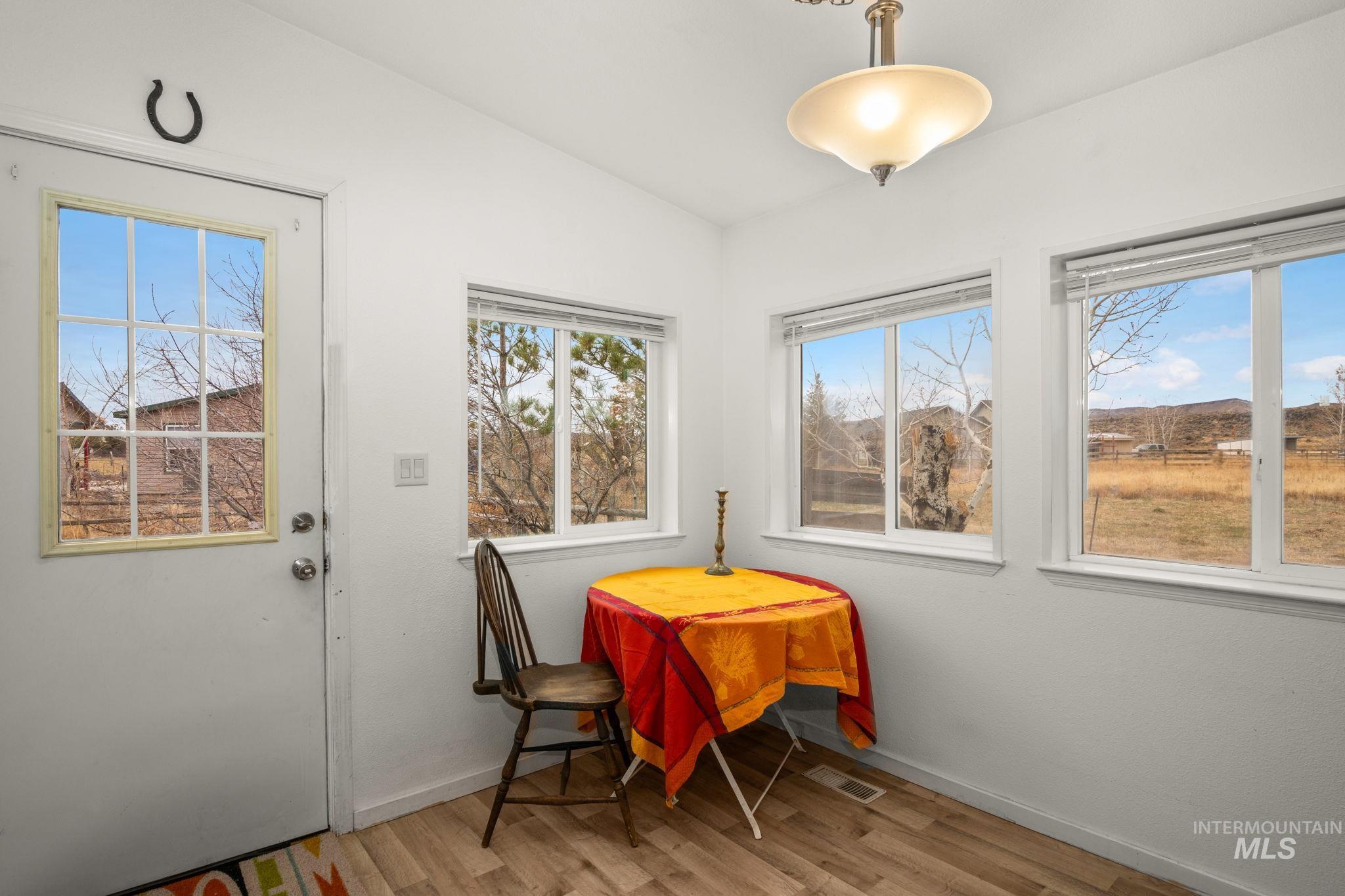 Dining room featuring wood finished floors and baseboards