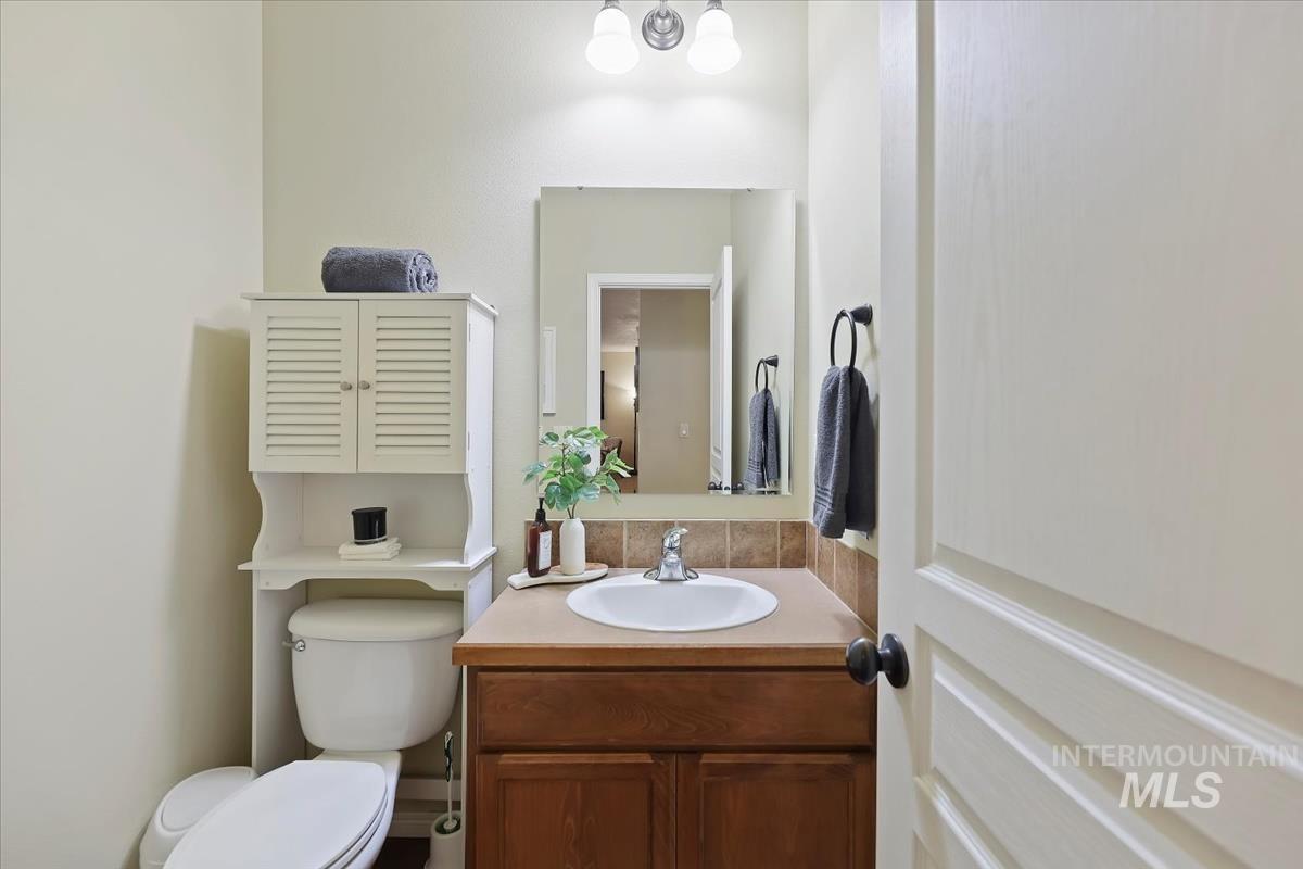 Half bathroom featuring vanity and a chandelier
