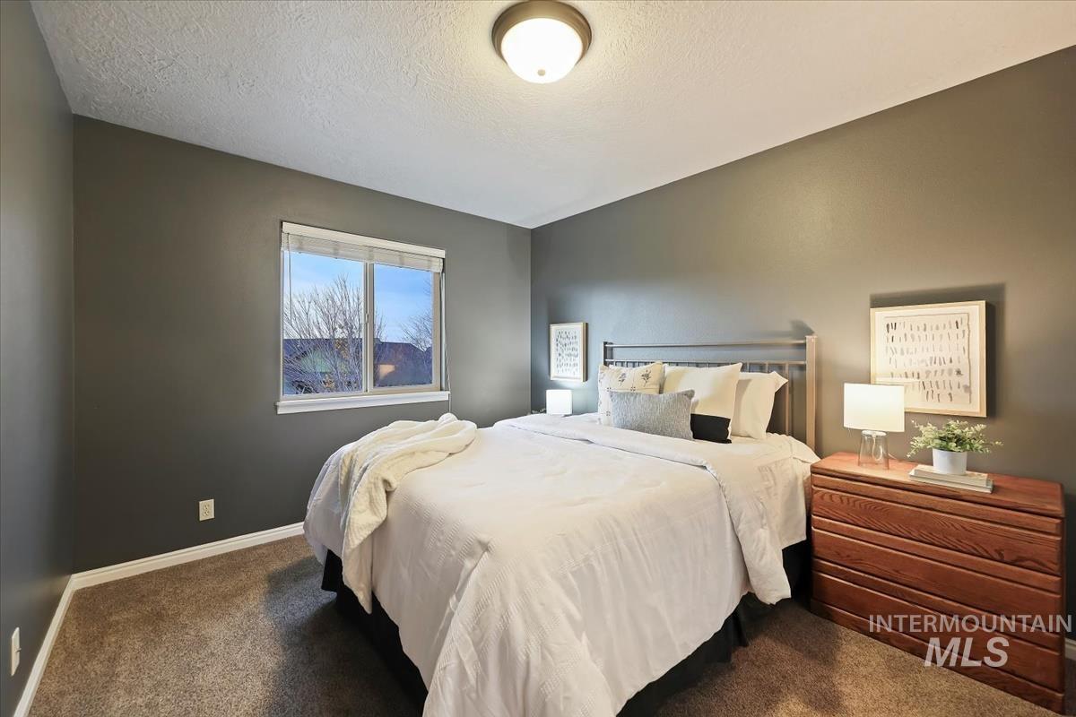 Bedroom with carpet and a textured ceiling
