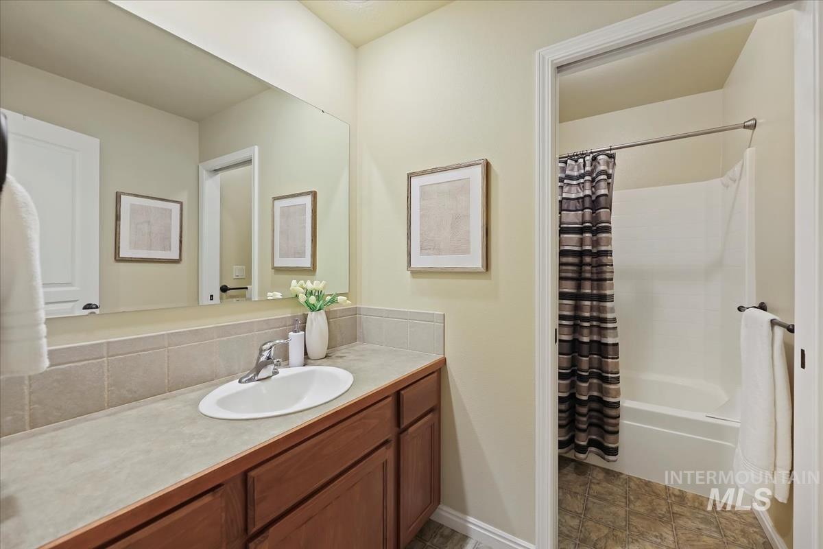 Full bath with vanity and shower / bathtub combination with curtain