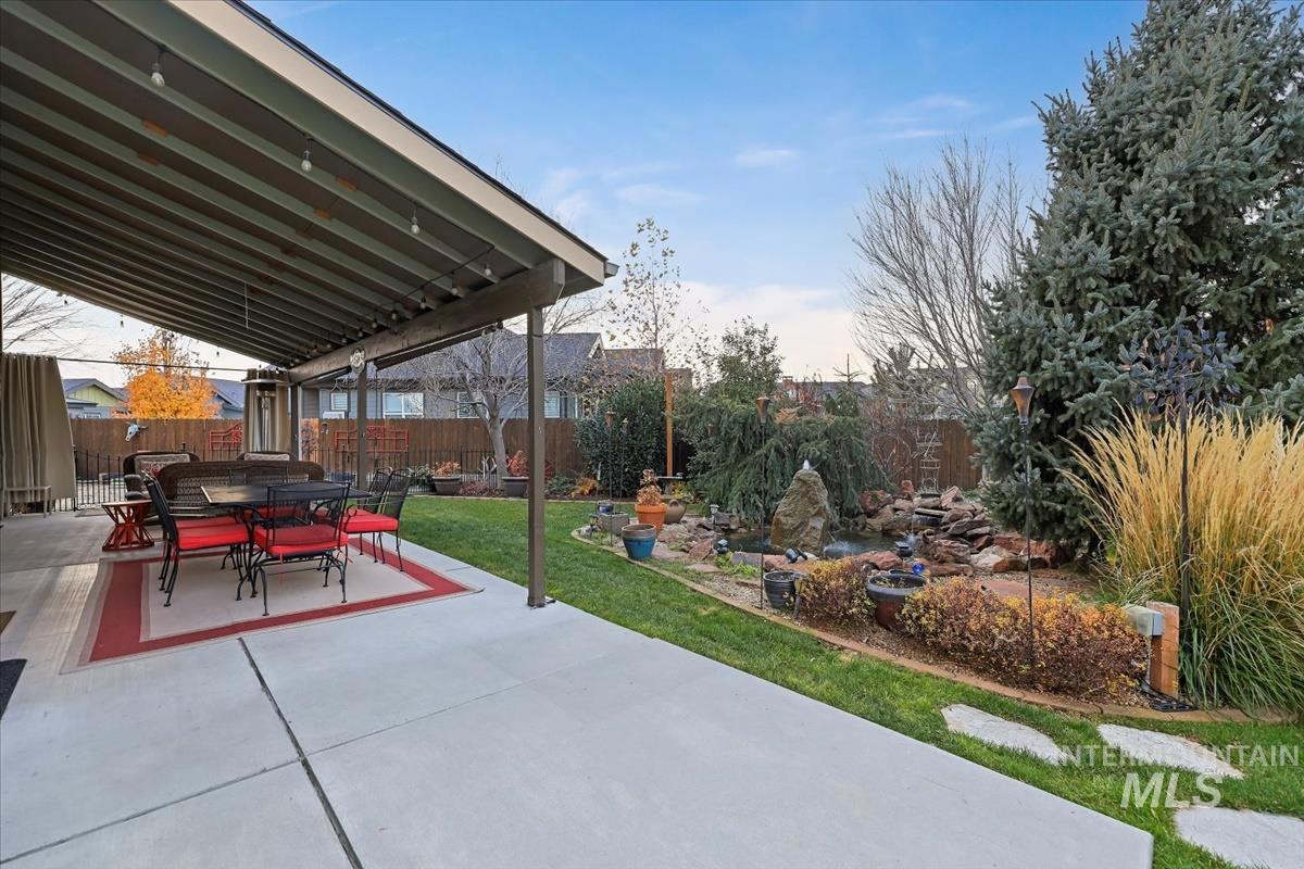 Fenced backyard featuring a patio and outdoor dining area