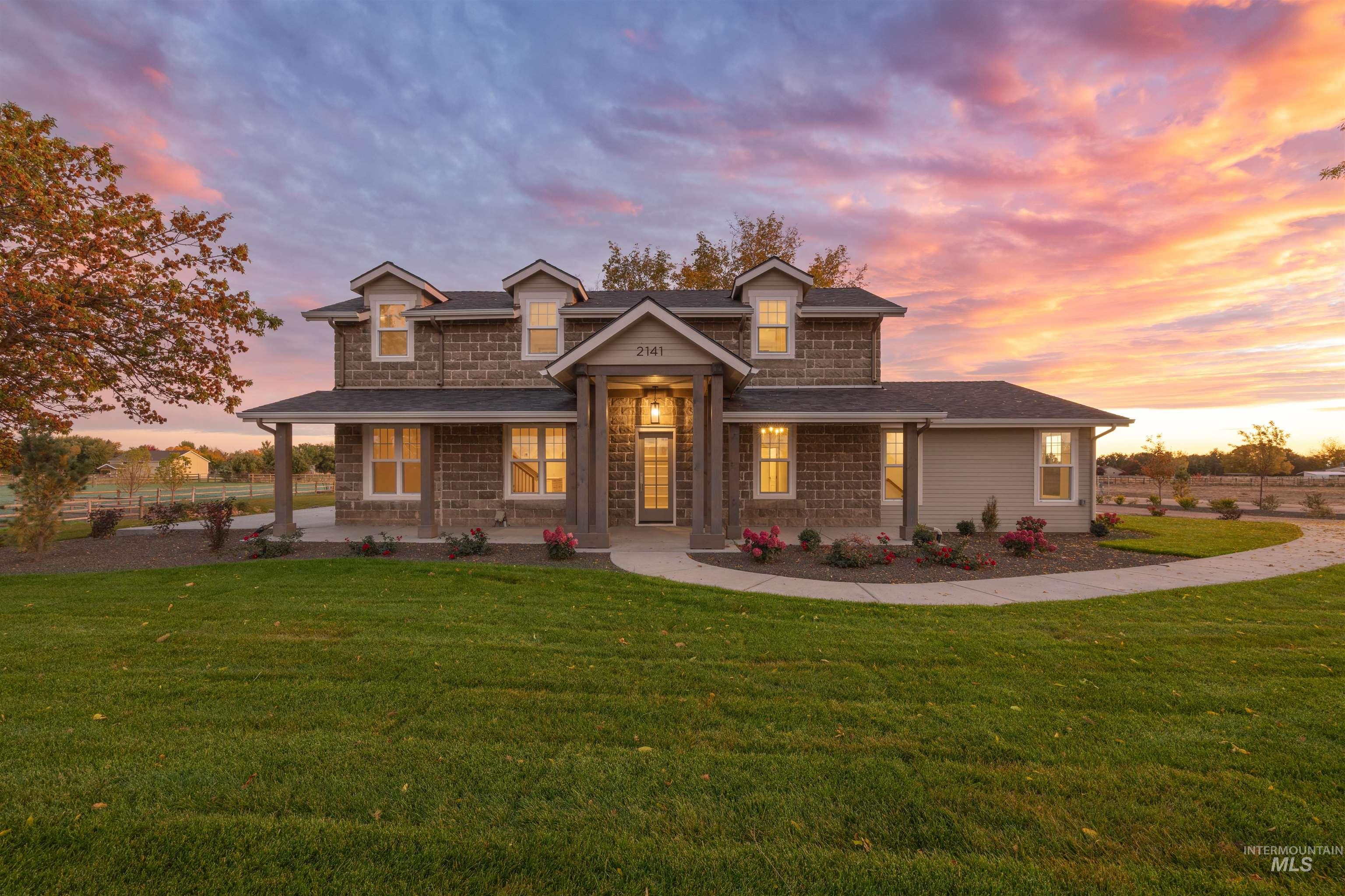 Shingle-style home with a front yard, a porch, and roof with shingles
