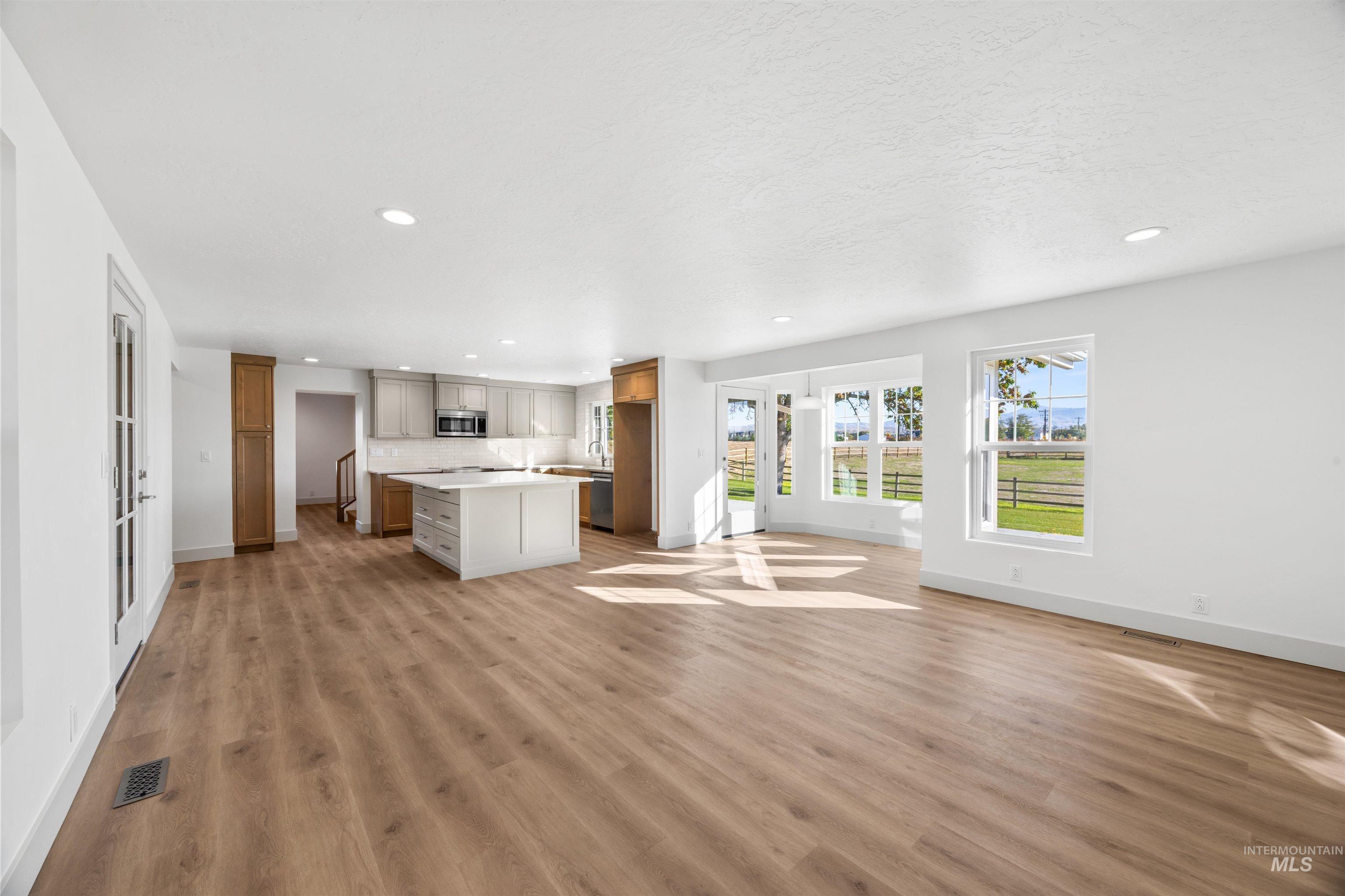 Unfurnished living room featuring recessed lighting and light wood-type flooring