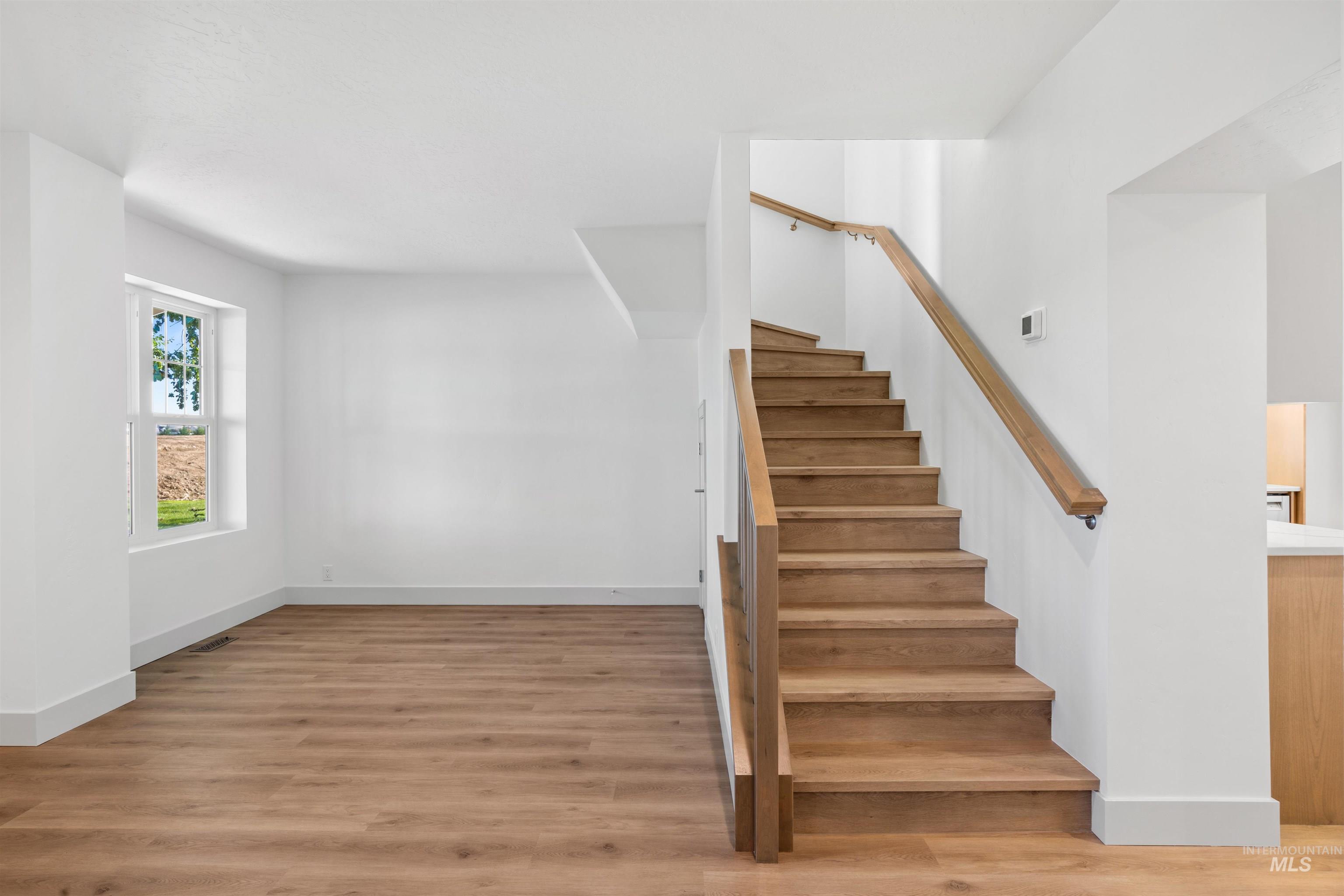 Staircase featuring wood finished floors