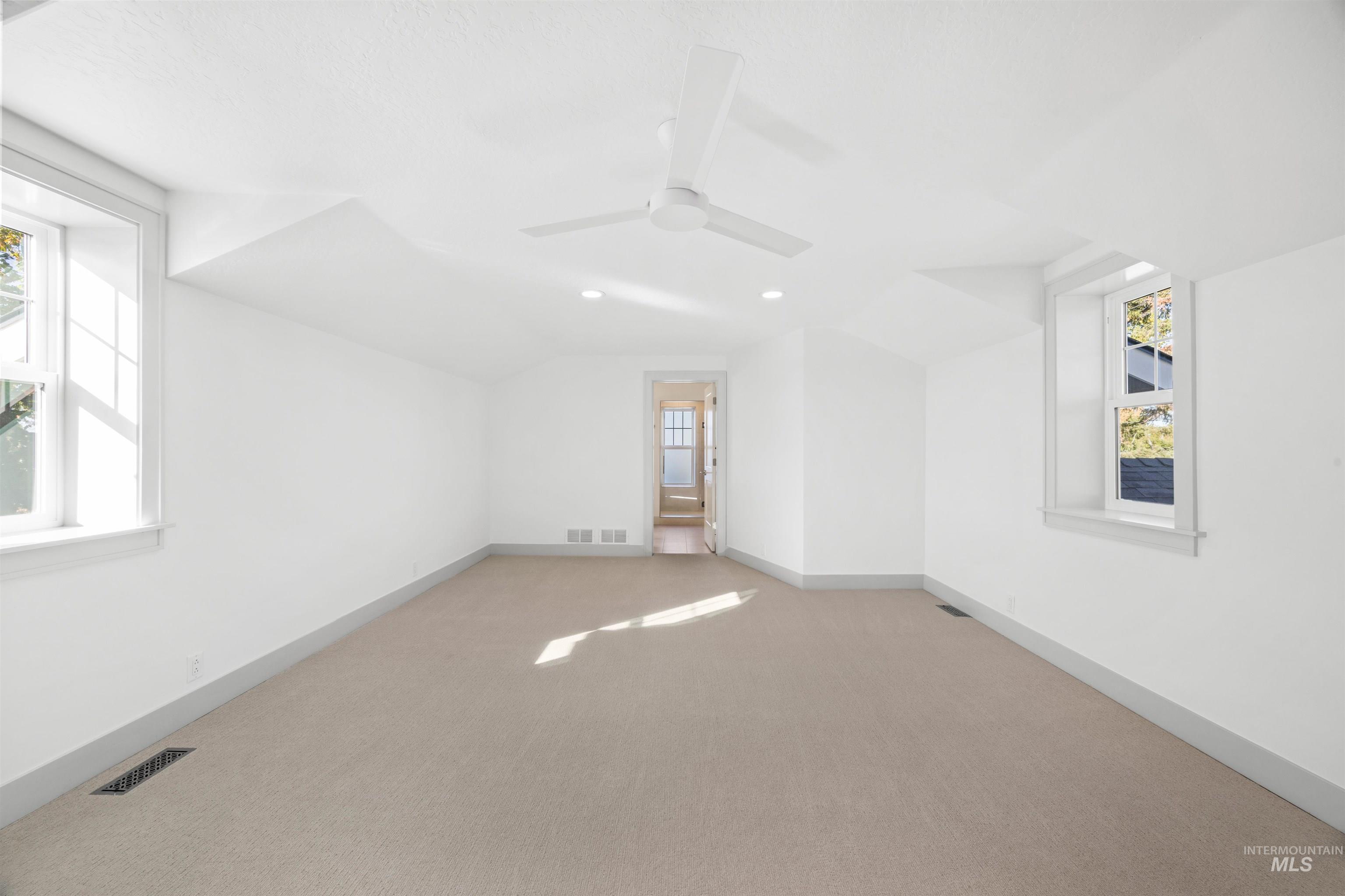 Bonus room featuring carpet floors, vaulted ceiling, recessed lighting, and a ceiling fan