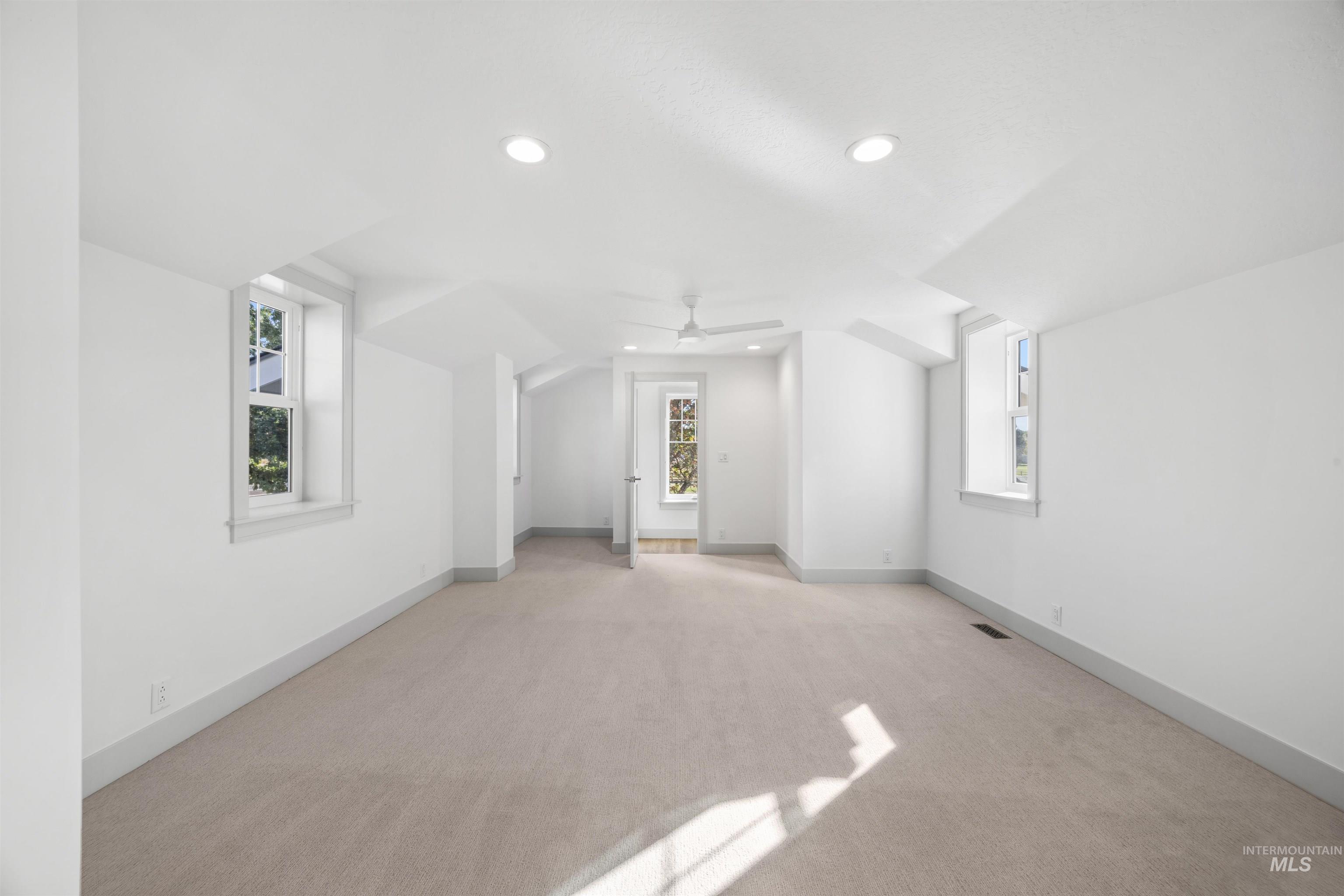 Additional living space featuring carpet flooring, recessed lighting, and ceiling fan