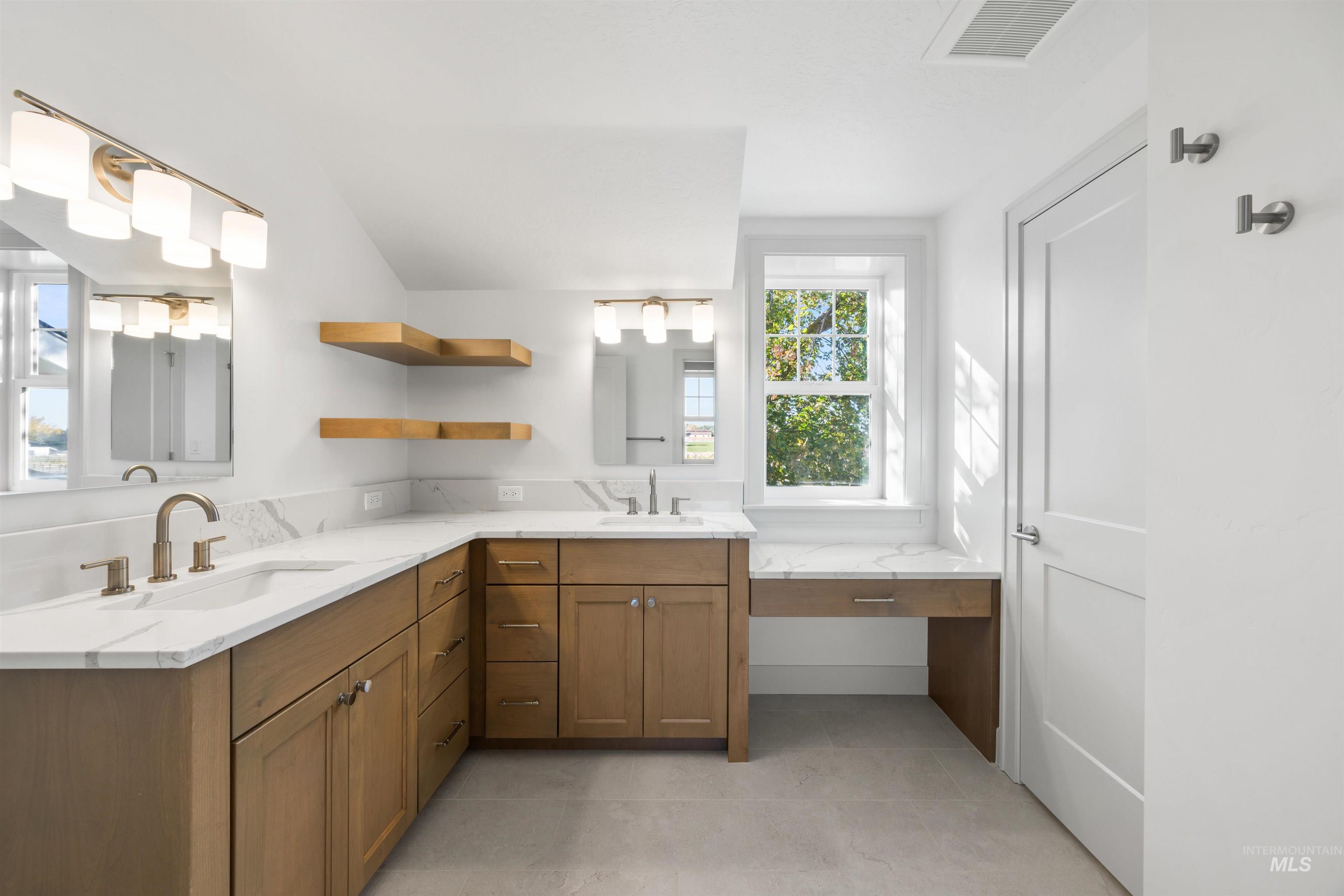 Full bathroom featuring double vanity and light tile patterned floors