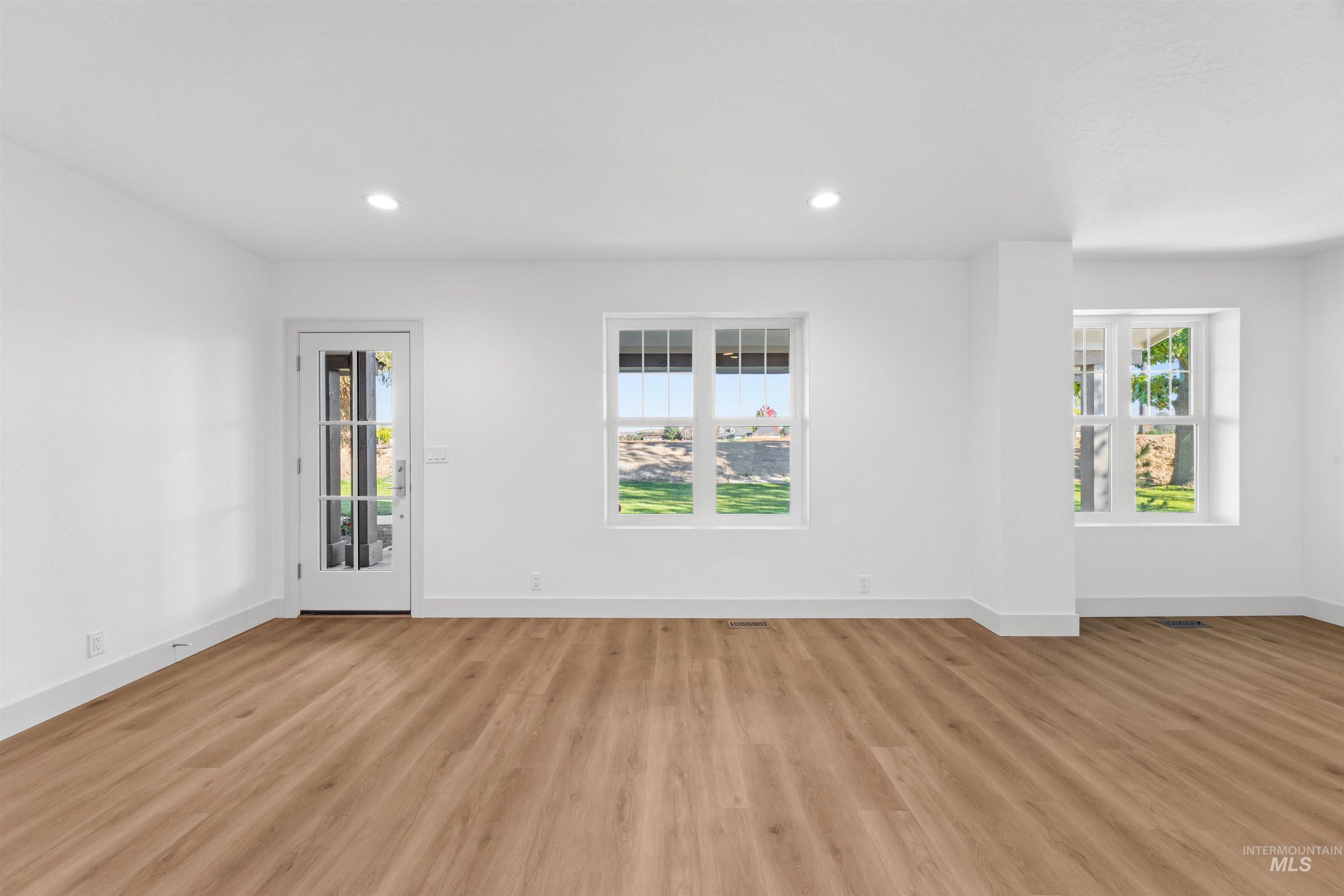 Empty room featuring recessed lighting and light wood-style floors