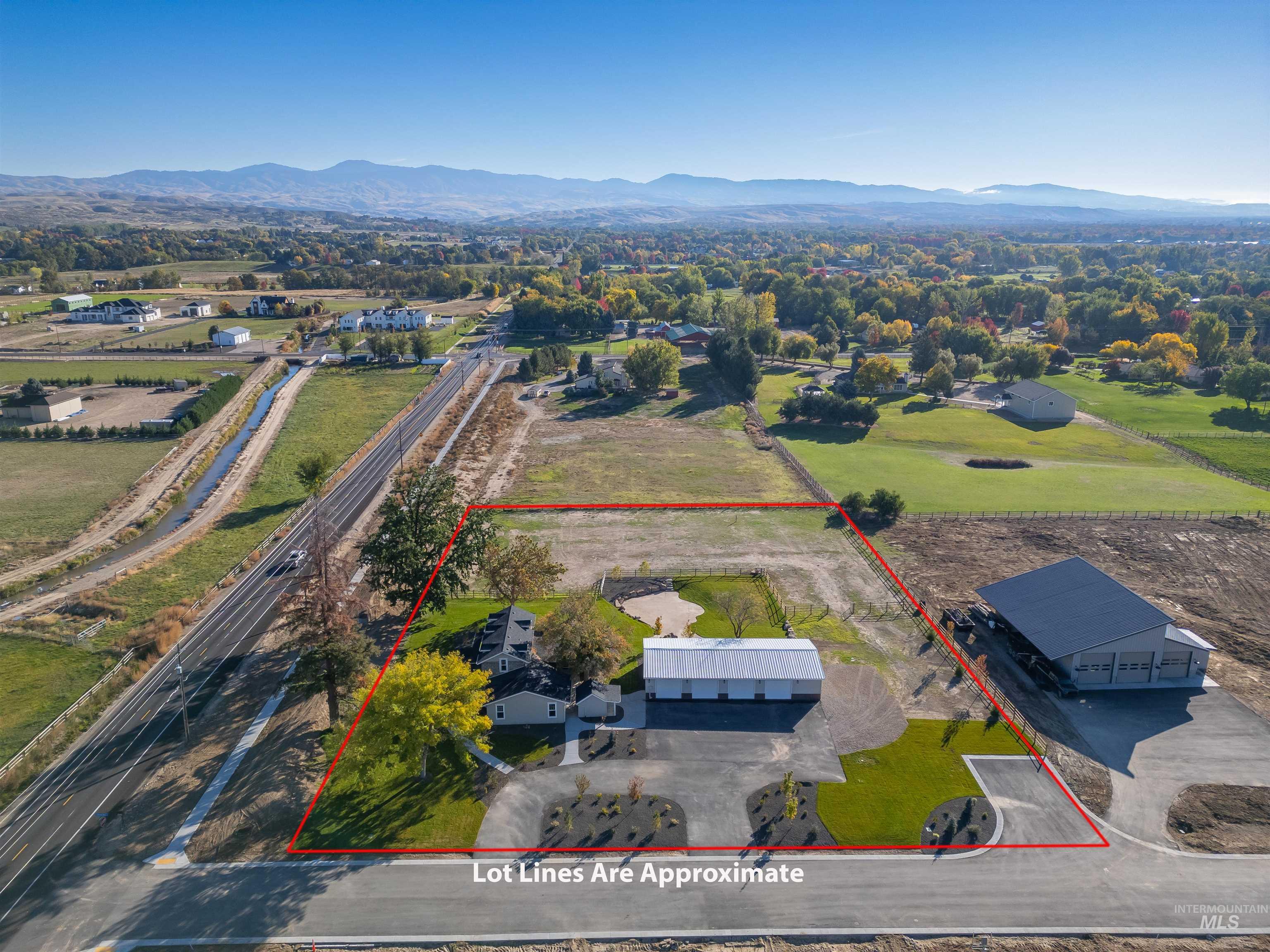 Aerial view of property's location with a mountain backdrop and property parcel outlined