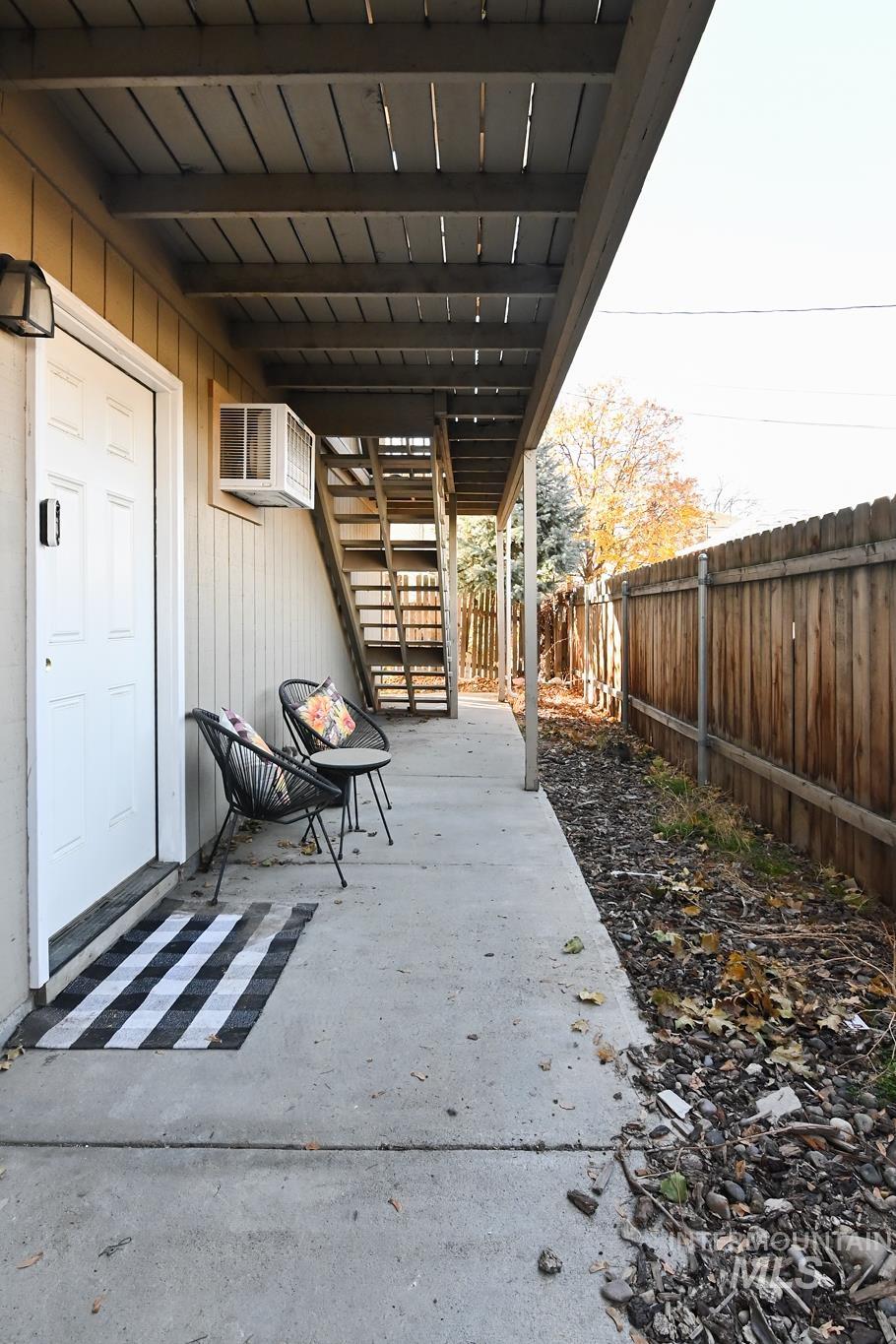 Fenced backyard featuring stairs and a patio
