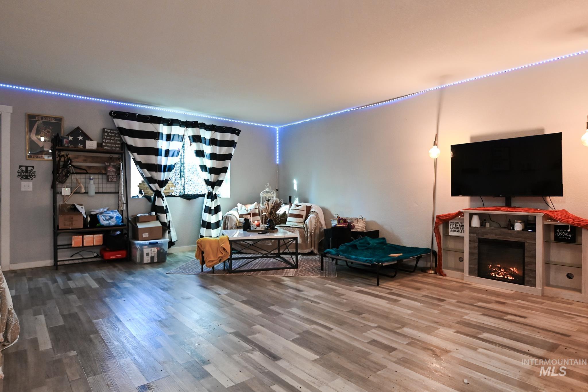Living room featuring wood finished floors and a tiled fireplace