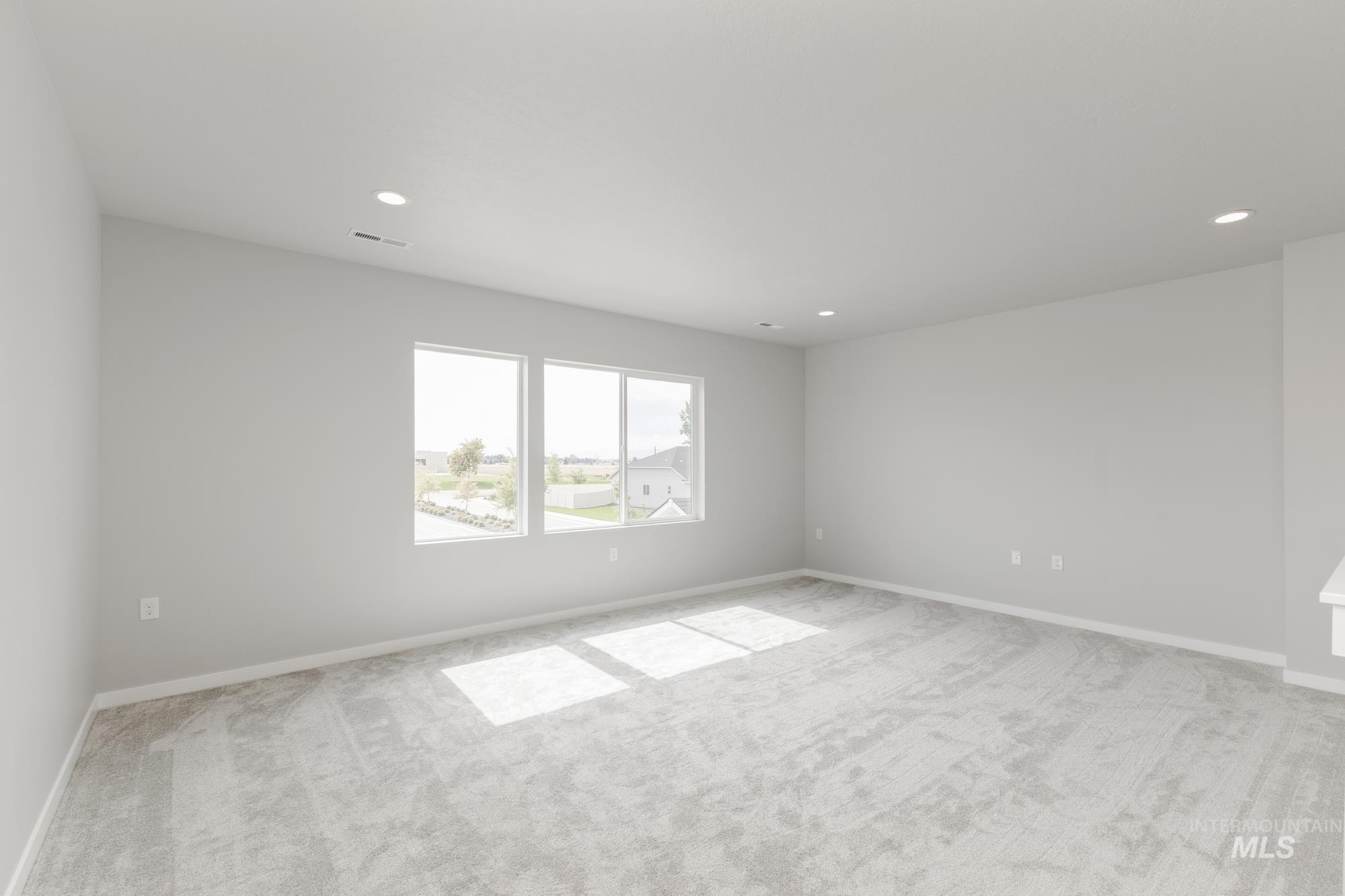 Spare room featuring light carpet and recessed lighting