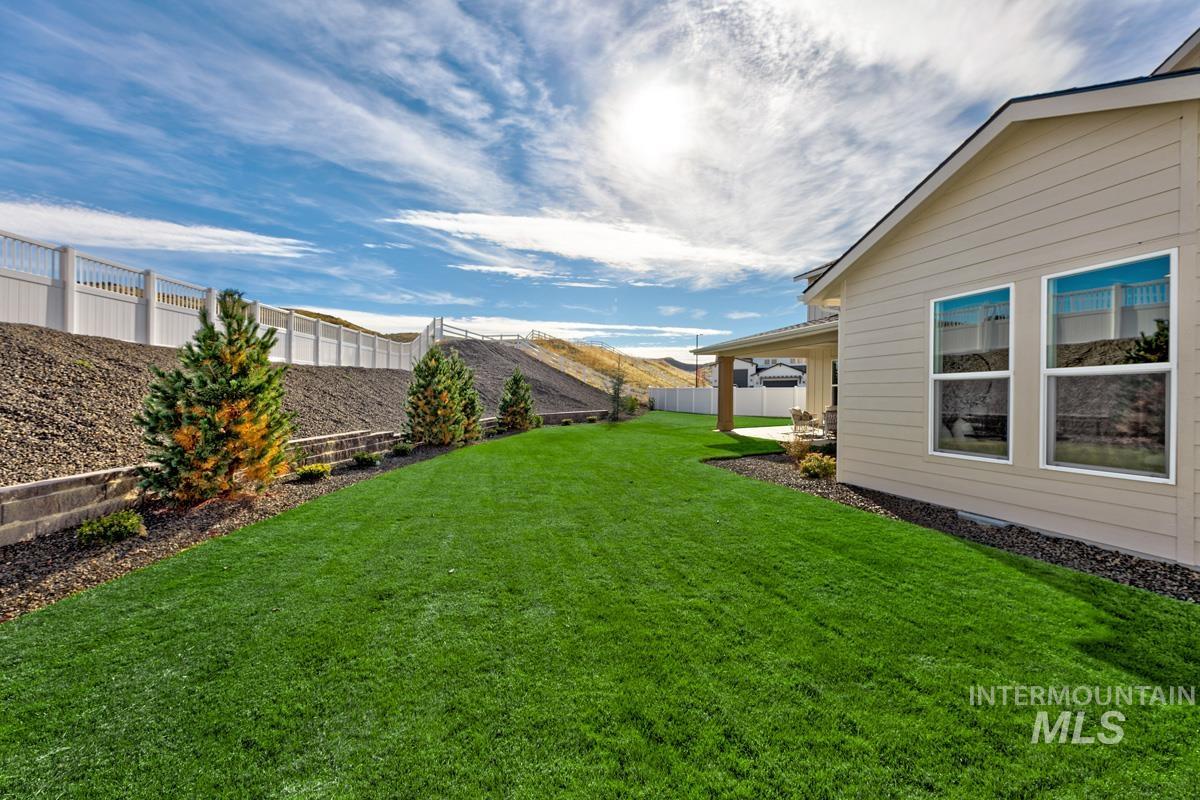 Fenced backyard featuring a mountain view and a patio