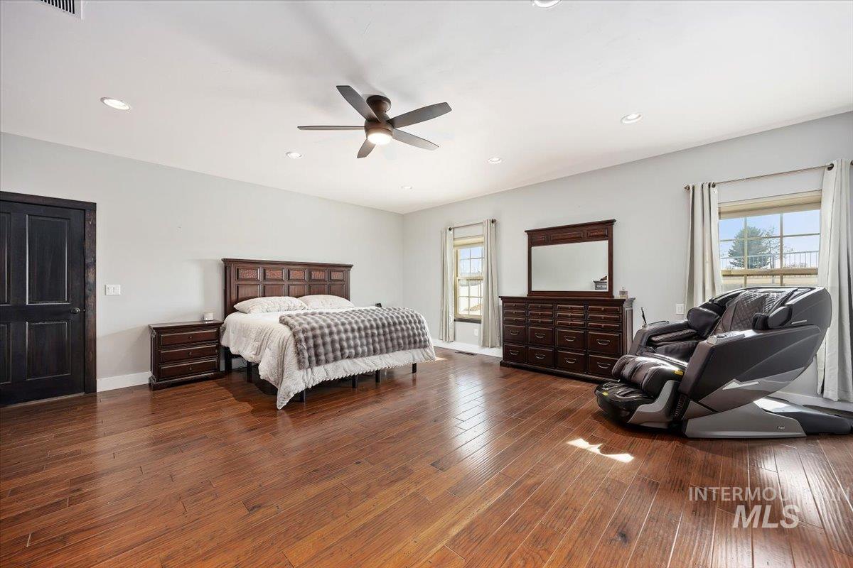 Bedroom featuring dark wood-style flooring, recessed lighting, and a ceiling fan