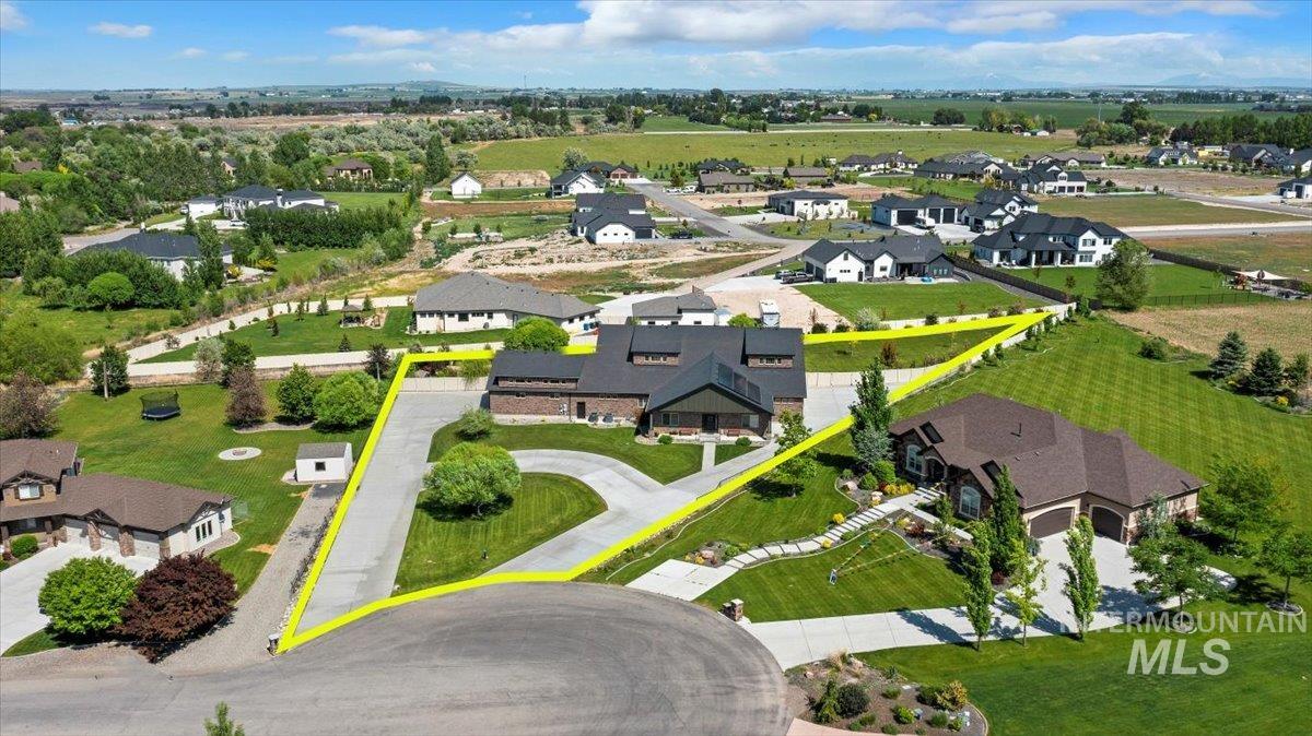 Aerial perspective of suburban area featuring property boundaries highlighted