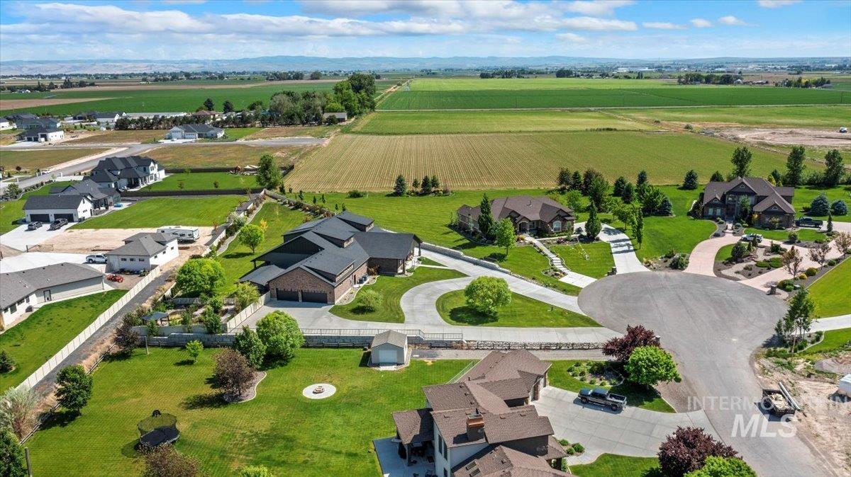 Aerial view of property and surrounding area with rural landscape and large plots for crops