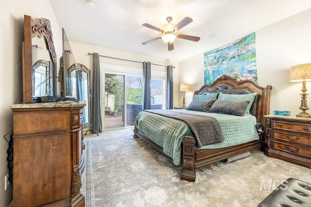 Carpeted bedroom with access to exterior and ceiling fan