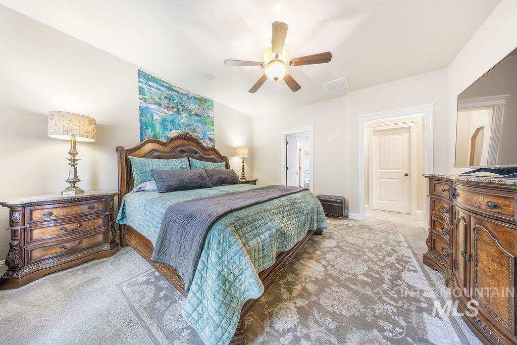 Bedroom featuring light carpet and ceiling fan