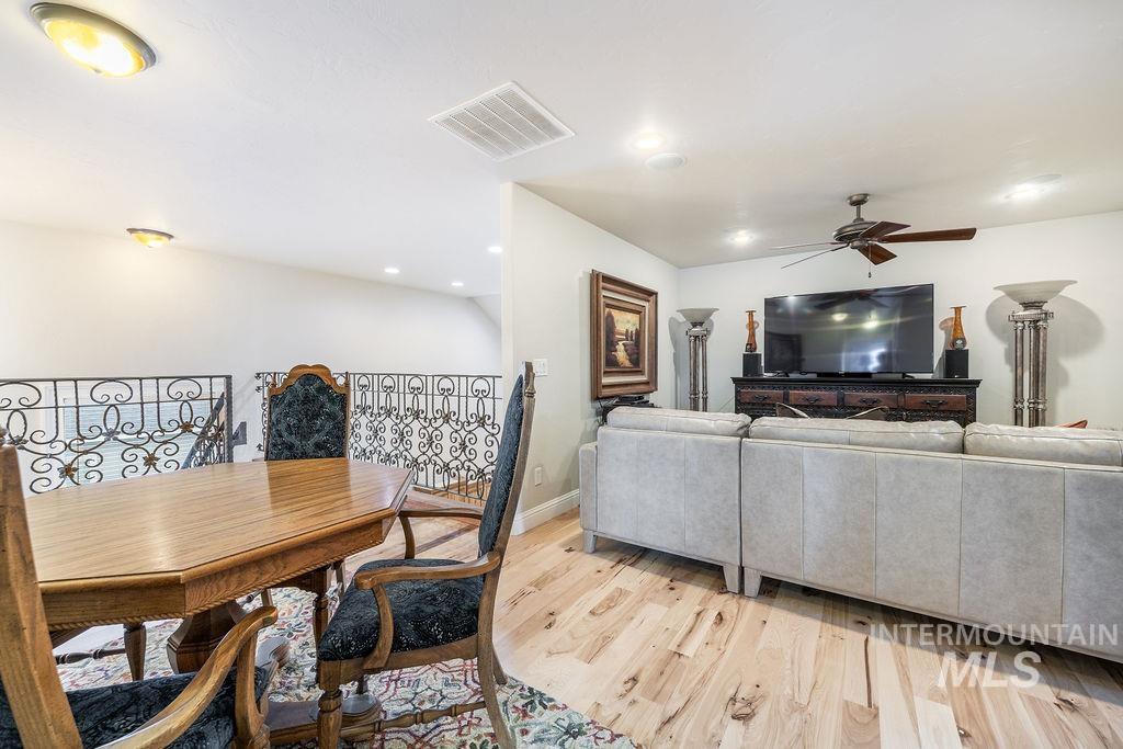 Dining area featuring a ceiling fan, light wood finished floors, and recessed lighting