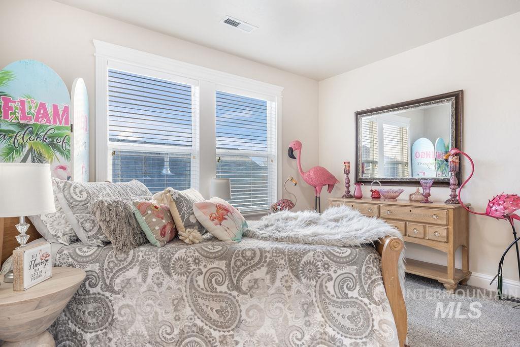 Carpeted bedroom featuring baseboards