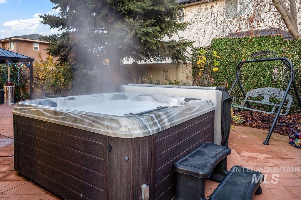 View of patio featuring a gazebo and a hot tub