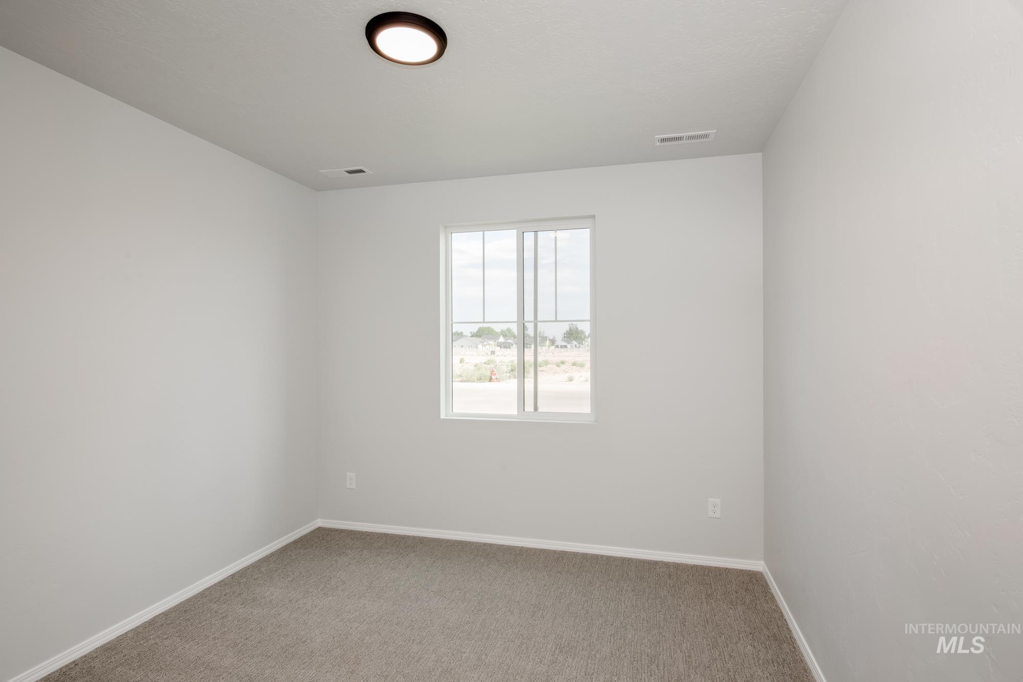 Unfurnished room with carpet flooring and baseboards