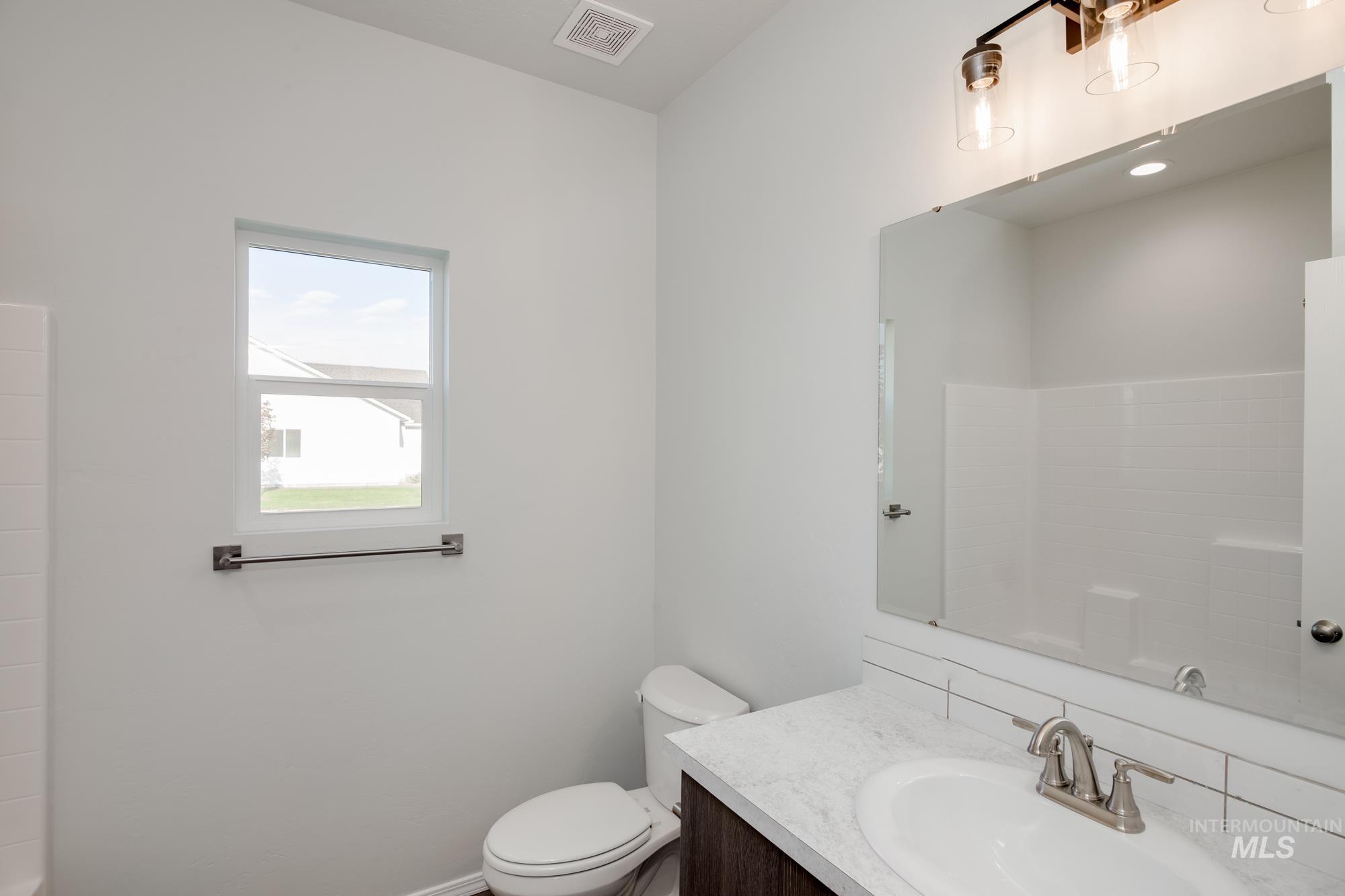 Bathroom featuring vanity and toilet
