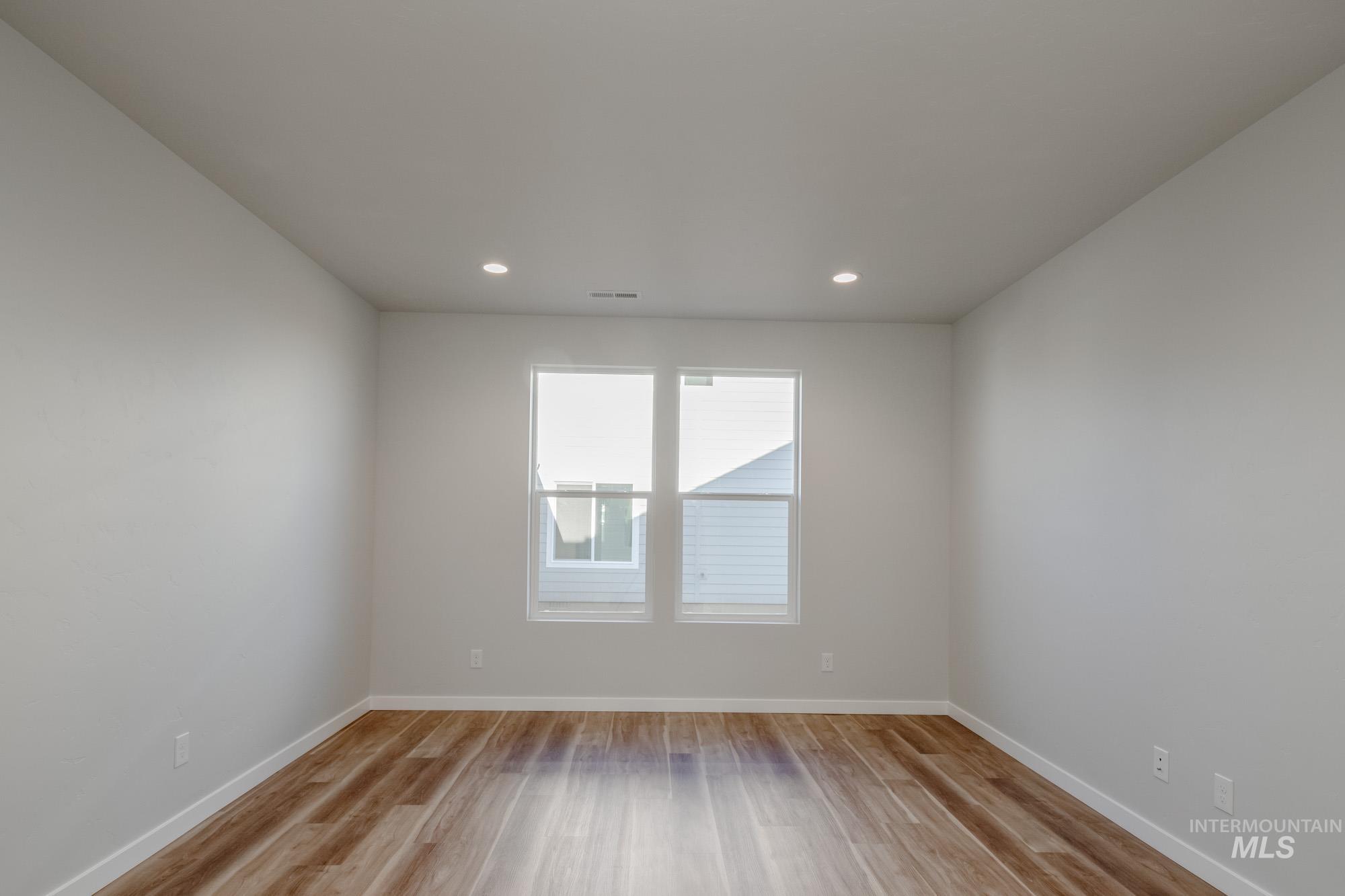 Spare room featuring light wood-style floors and recessed lighting